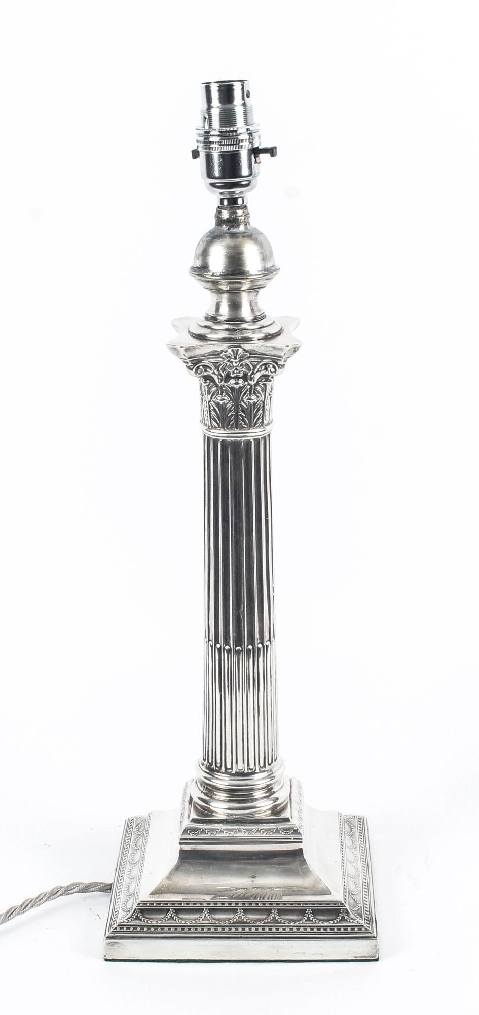 This is an impressive large antique Edwardian sterling silver Corinthian column table lamp bearing hallmarks for Sheffield 1908 and the makers mark of the renowned silversmith Hawksworth, Eyre & Co Ltd.

It features a classic Corinthian Capital