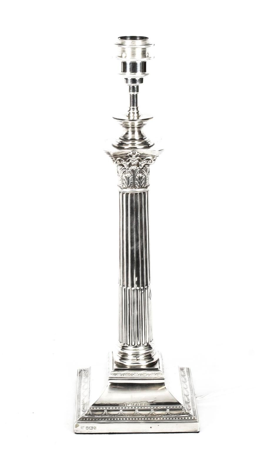This is an impressive large antique Edwardian sterling silver Corinthian column table lamp bearing hallmarks for Sheffield 1908 and the makers mark of the renowned silversmith Hawksworth, Eyre & Co Ltd

It features a classic Corinthian Capital