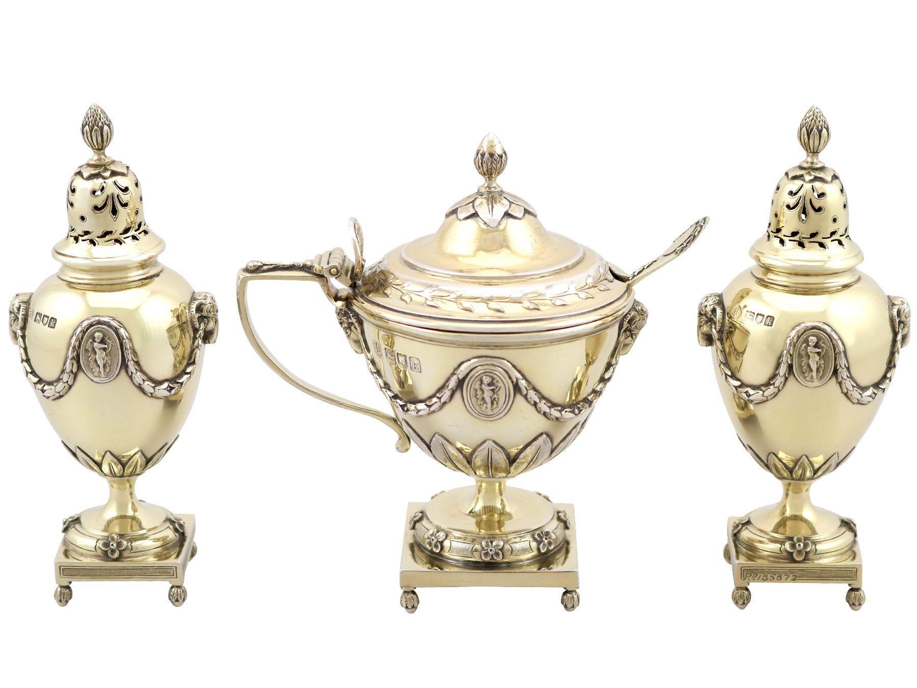 An exceptional, fine and impressive antique Edwardian English sterling silver gilt three piece condiment/cruet set - boxed; an addition to our dining silverware collection.

This exceptional antique Edwardian English sterling silver condiment set