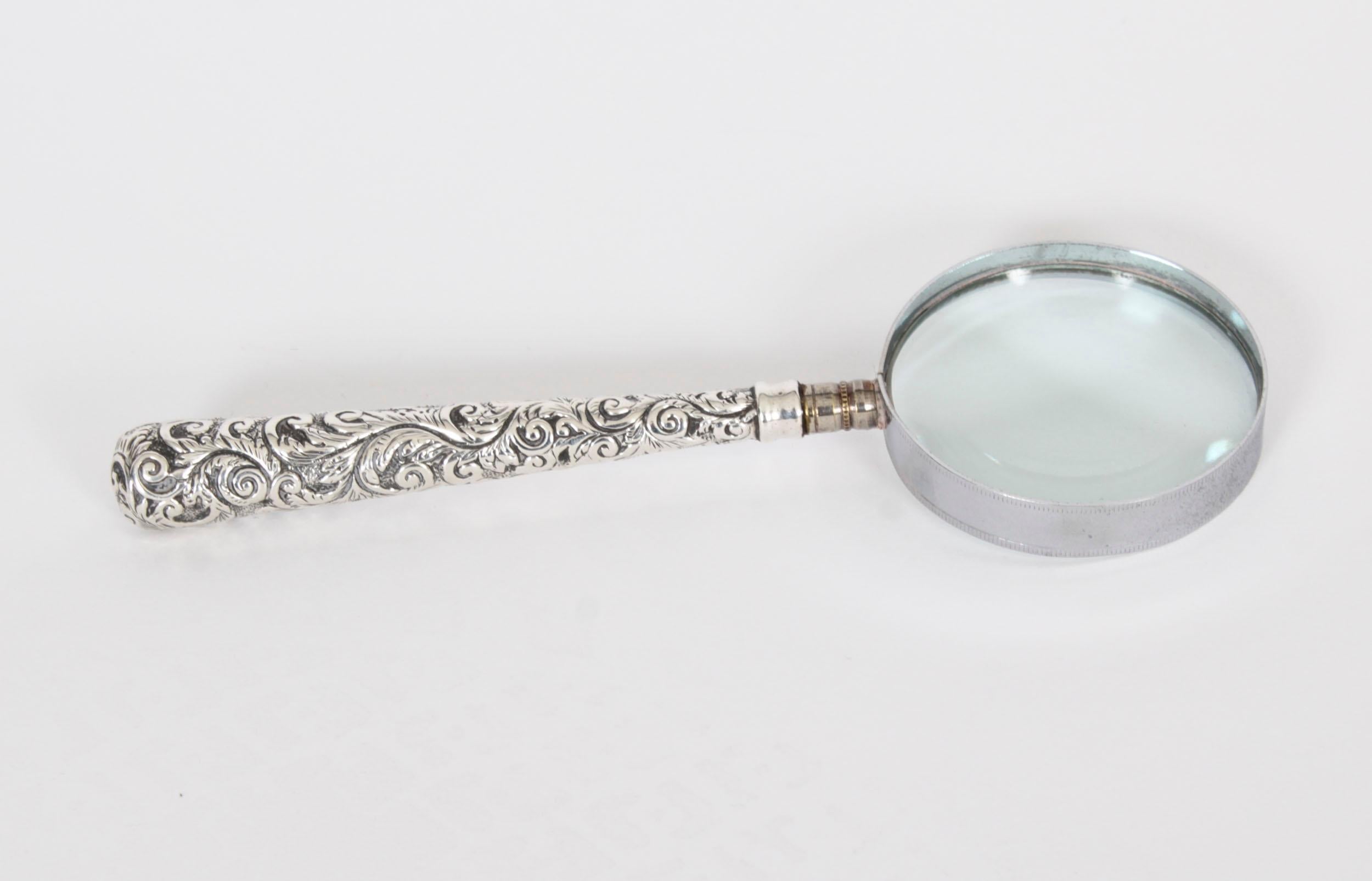 This is an exquisite Edwardian sterling silver magnifying glass with hallmarks for Birmingham 1907 and the makers mark of the renowned retailer and silversmith, Adie & Lovekin Ltd.

It features a handle with embossed floral decoration with a hafted