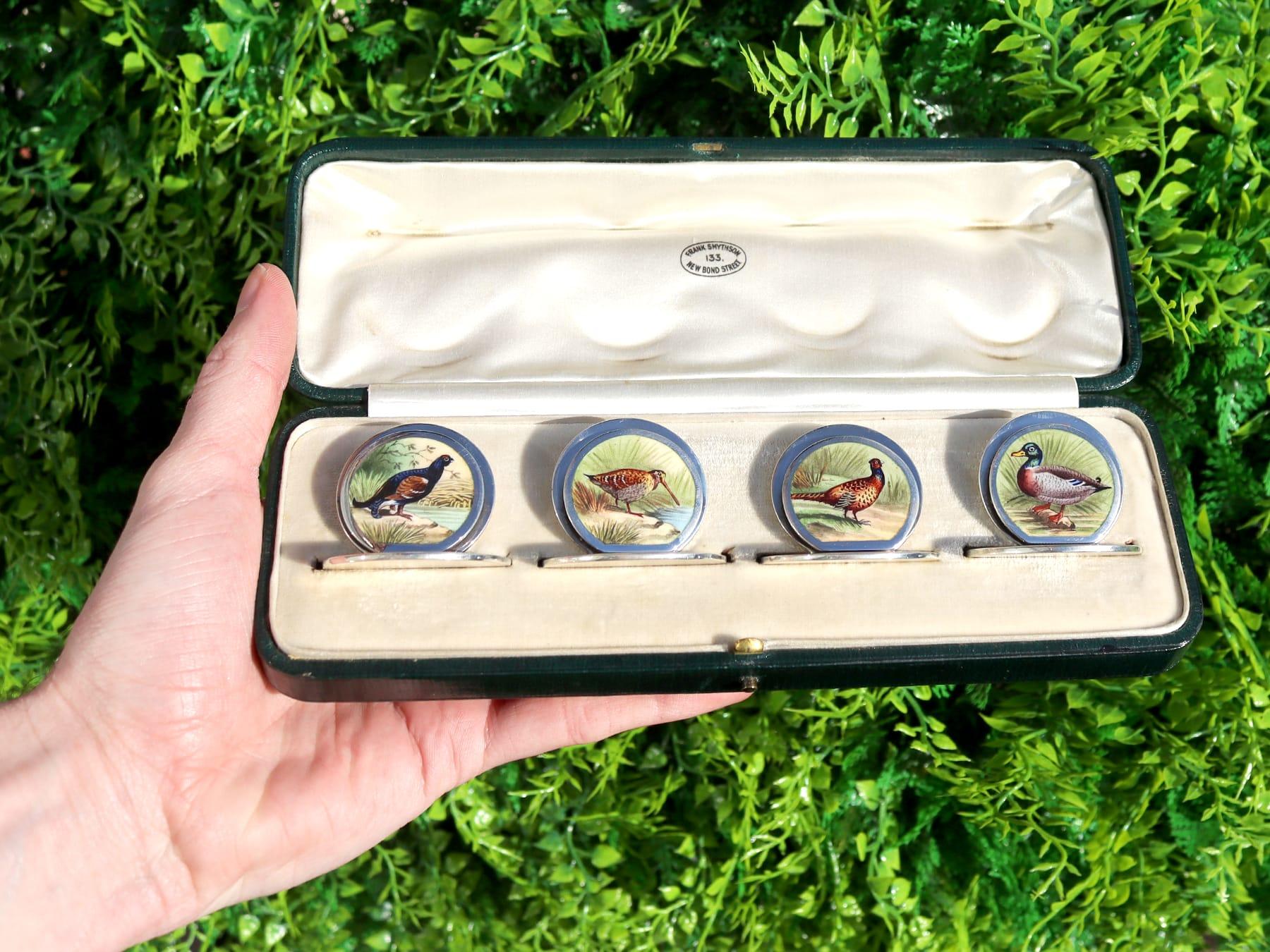 An exceptional, fine and impressive set of four antique Edwardian English sterling silver and enamel menu or card holders, boxed; an addition to our diverse dining silverware collection.

These exceptional antique Edwardian sterling silver menu