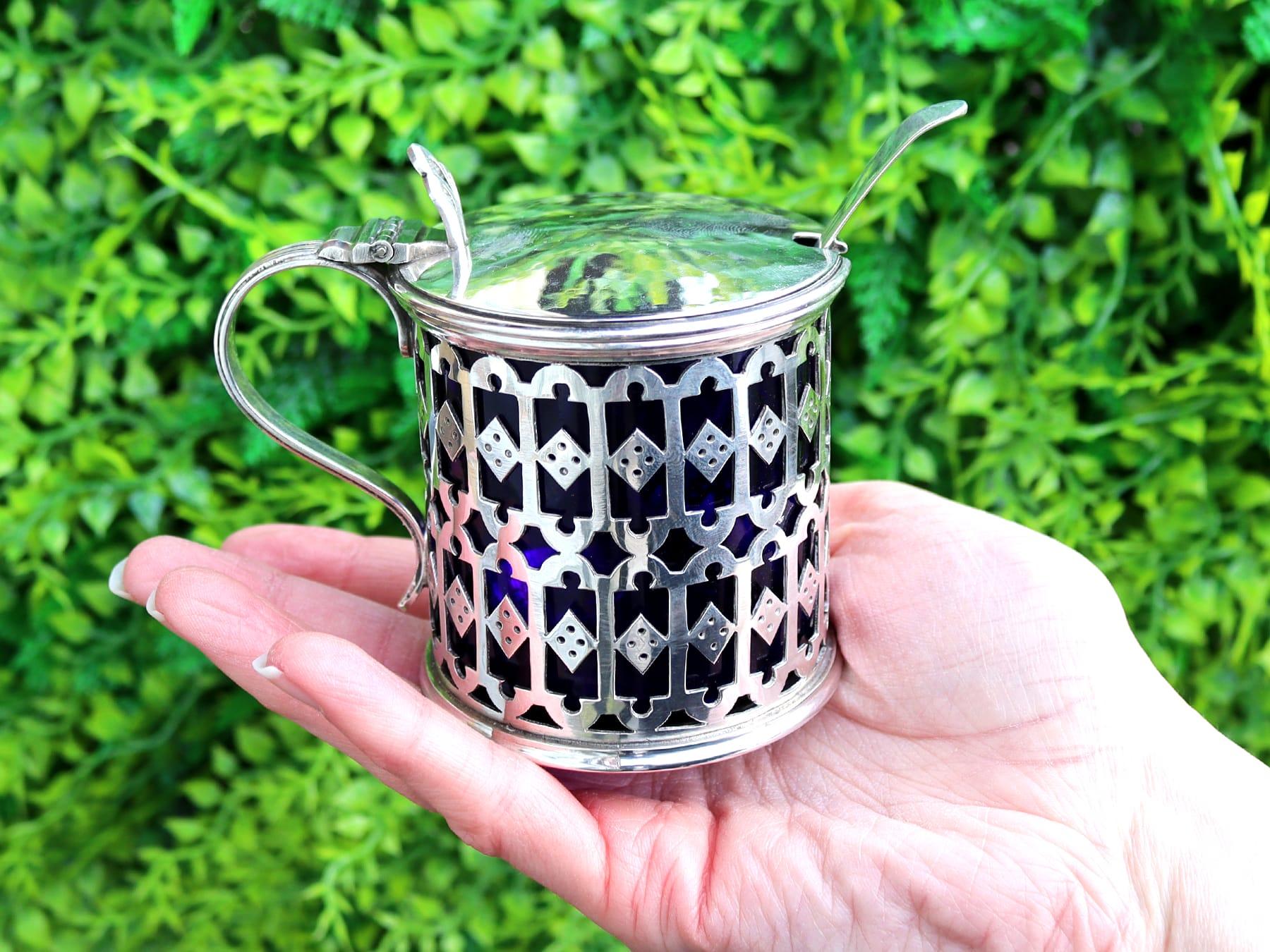 An exceptional, fine and impressive rare antique English sterling silver mustard pot with blue glass liner made by Omar Ramsden; an addition to our silver cruets/condiments collection.

This exceptional and rare antique sterling silver mustard pot