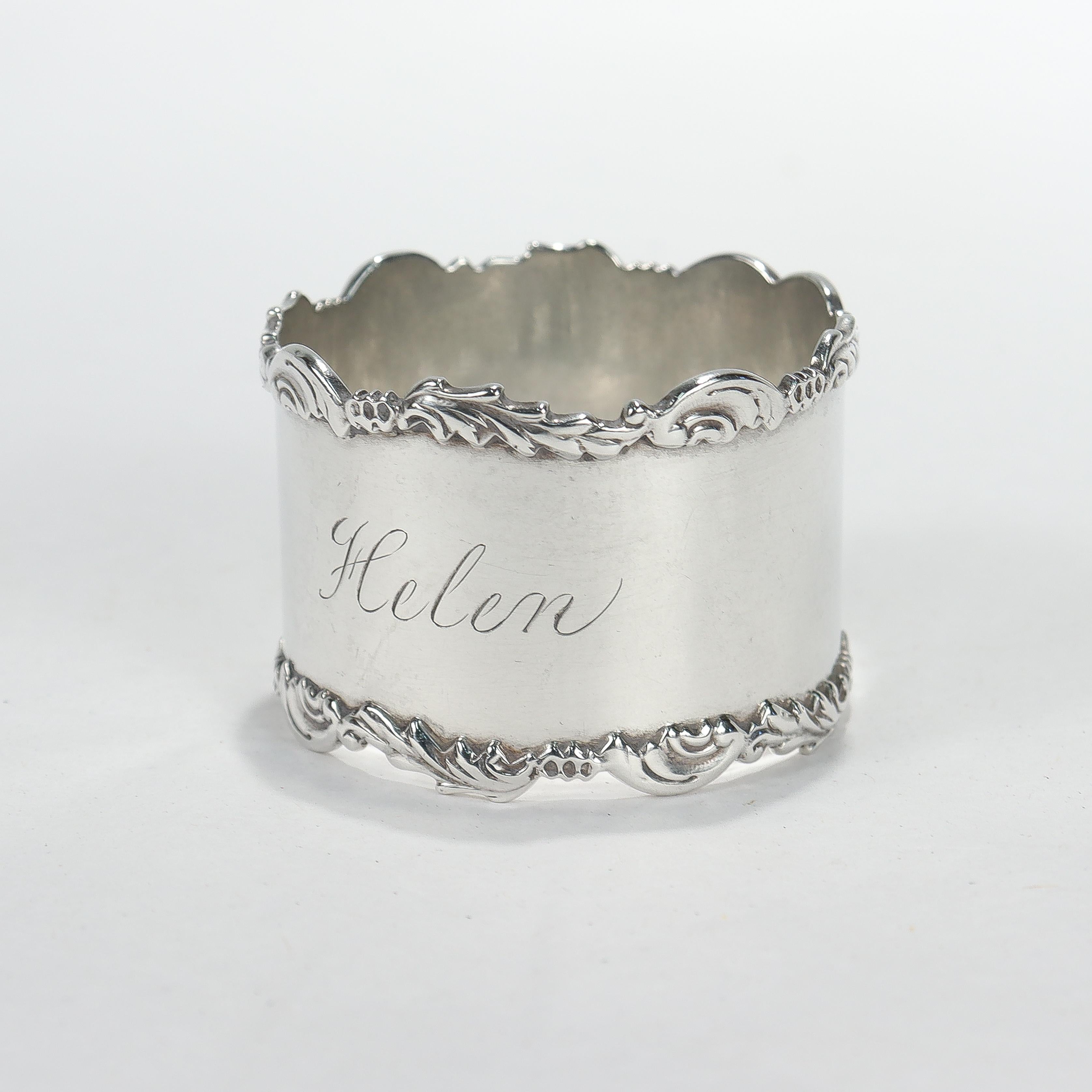 A fine Edwardian napkin ring.

In sterling silver.

With raised floral design to the edges and inscribed 