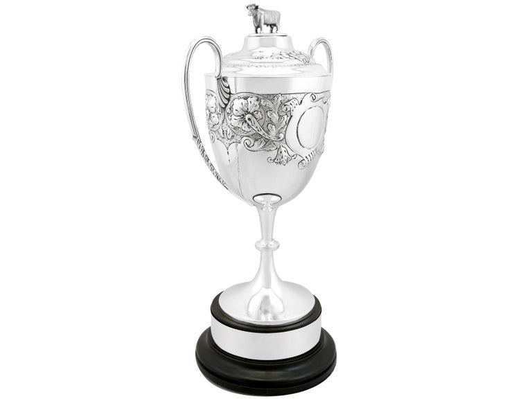 An exceptional, fine and impressive antique Edwardian English sterling silver cup and cover; an addition to our antique presentation silverware collection.

This exceptional antique sterling silver trophy cup has a circular bell shaped form onto a