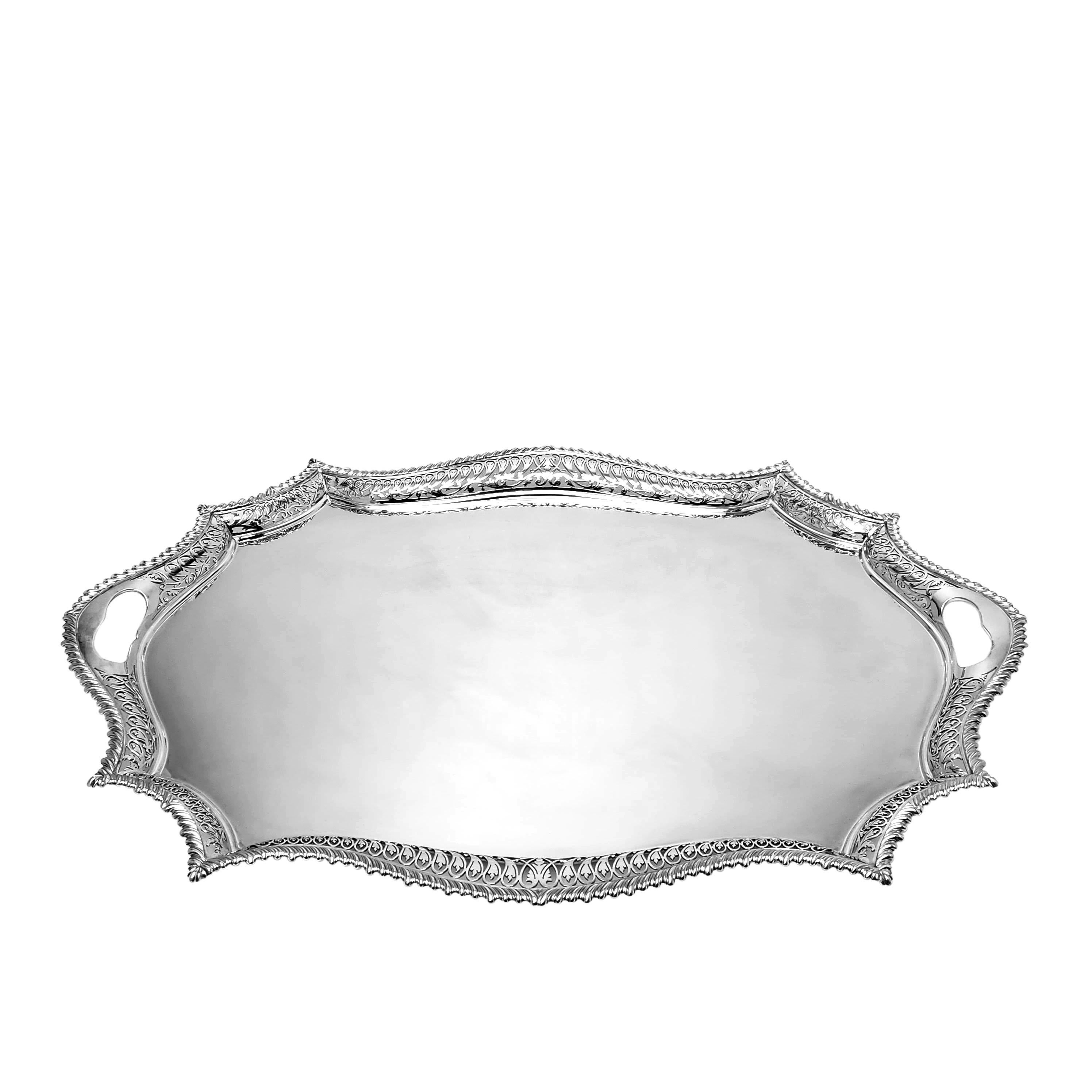 An elegant Silver Serving Tray a shaped rim and beautifully pierced border. The Tray is embellished with a classic gadroon edge on the shaped border. The Tray is of substantial size suitable for Tea Sets.

Made in London, England in 1906 by Reid &