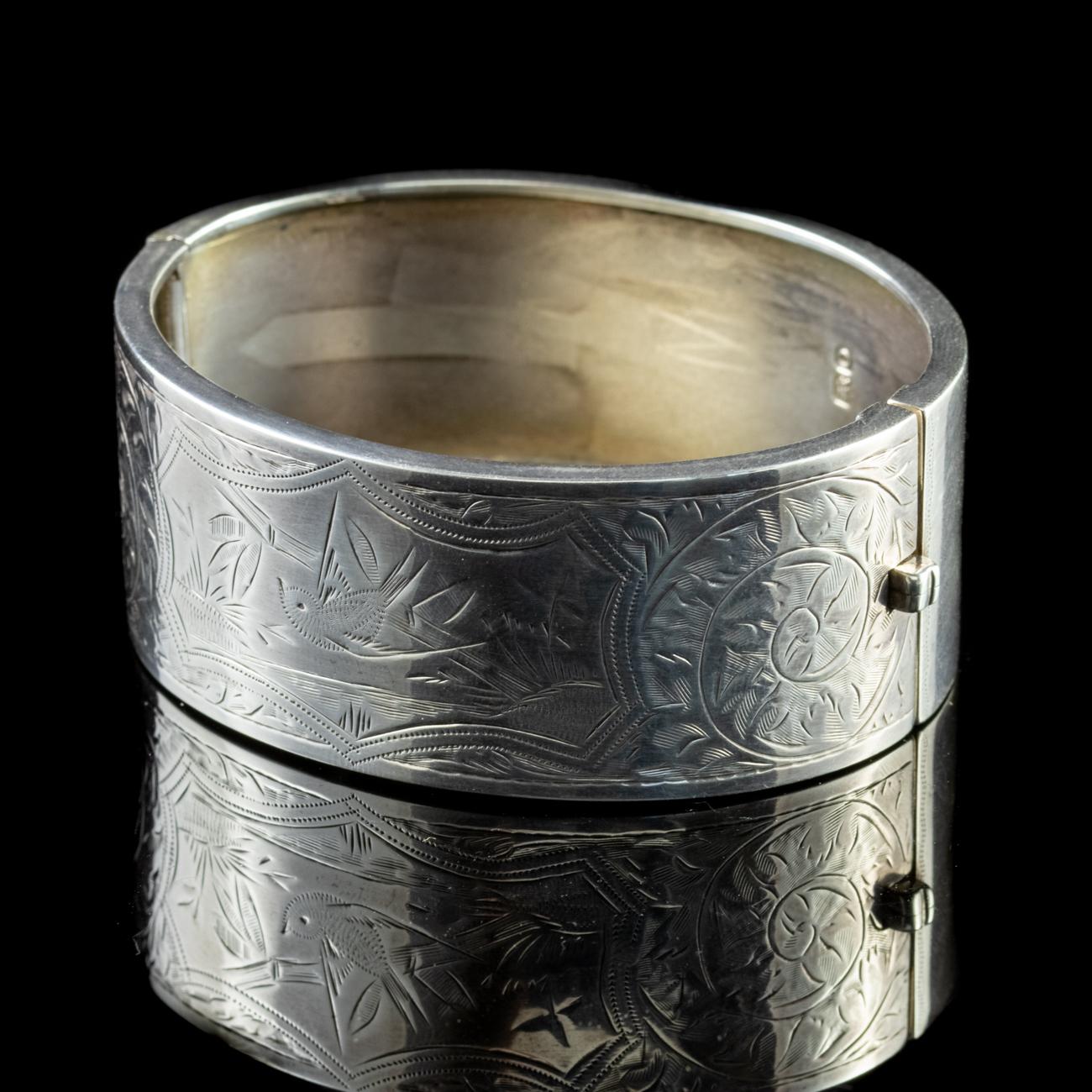 This striking Sterling Silver Edwardian bird bangle has been intricately engraved across the face with a pattern of natural forms surrounding a single swallow in flight.

Swallows are known to mate for life, and symbolise love and faithfulness. The