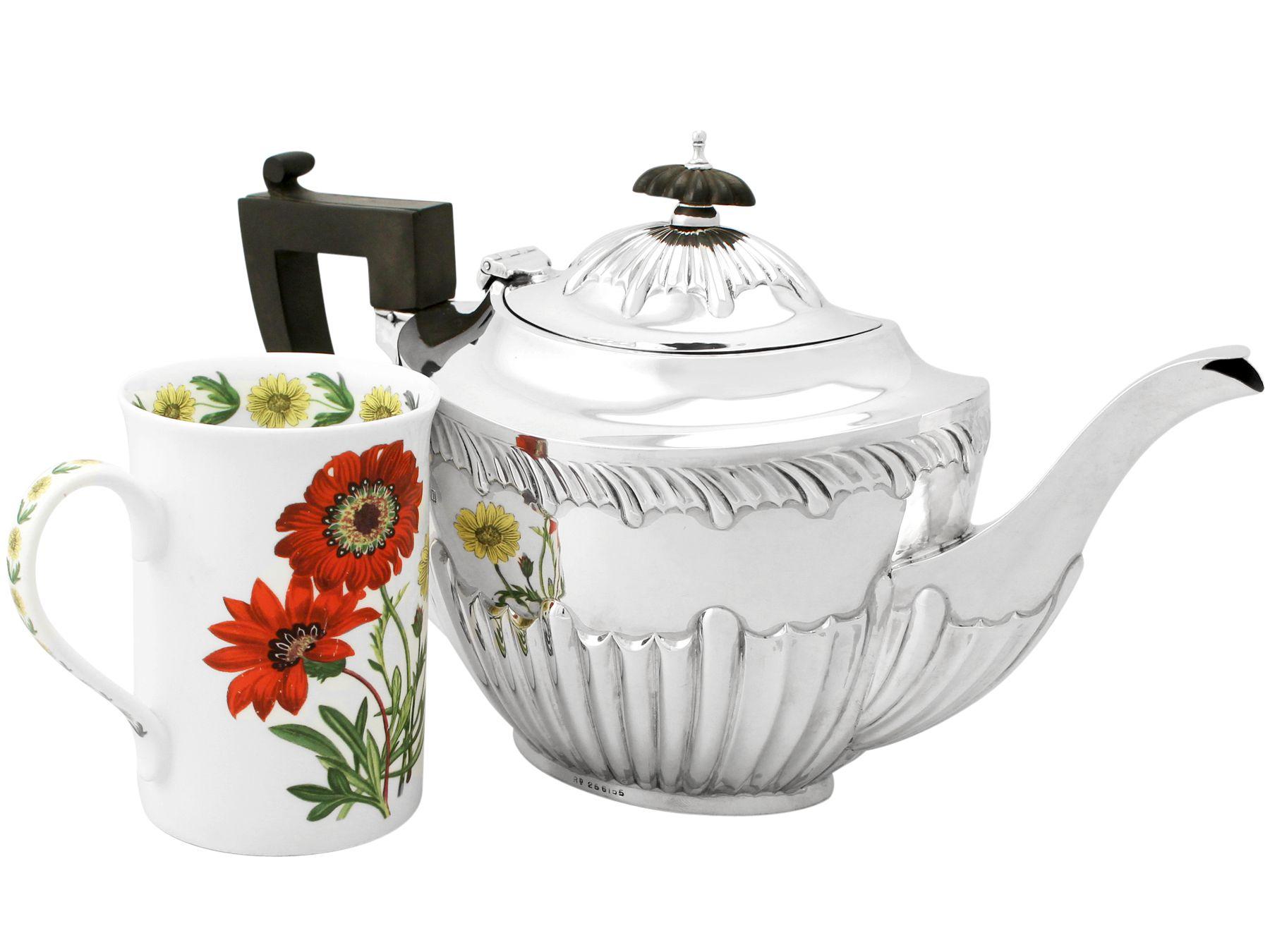 A fine and impressive antique Edwardian English sterling silver teapot in the Queen Anne style, part of our diverse teaware collection.

This impressive antique Edwardian sterling silver teapot has been modelled in the Queen Anne style onto an oval