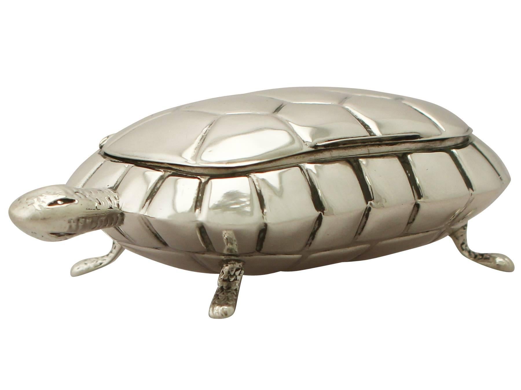 A fine and impressive, unusual antique Edwardian English sterling silver compact/trinket box modeled in the form of a tortoise; an addition to our ornamental silverware collection.

This fine antique Edwardian sterling silver compact/trinket box