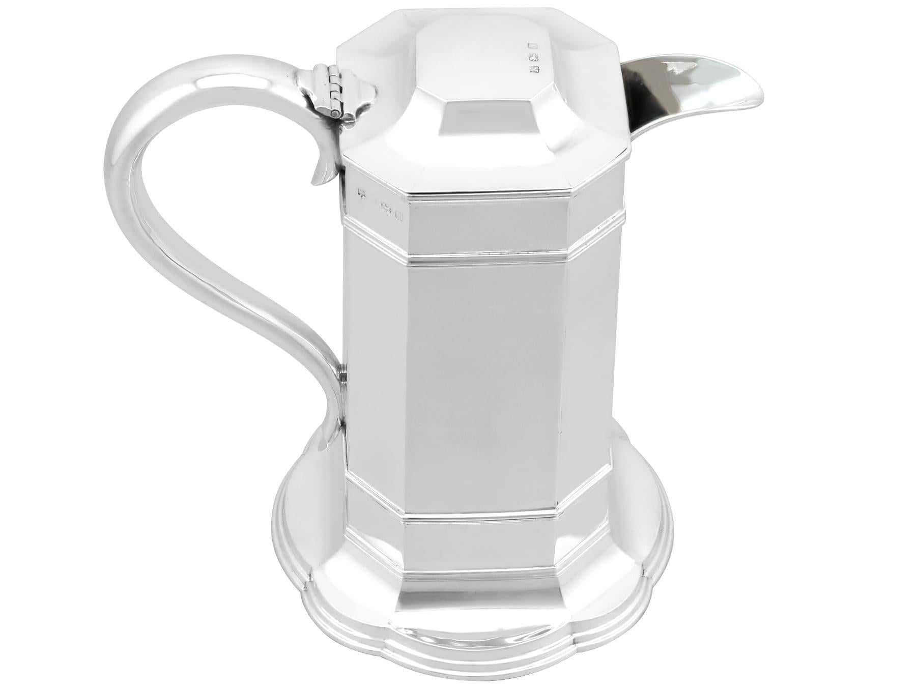 An exceptional, fine and impressive antique Edwardian English sterling silver wine flagon; an addition to our range of wine and drink related silverware.

This exceptional antique Edwardian sterling silver jug has an octagonal form onto an octofoil