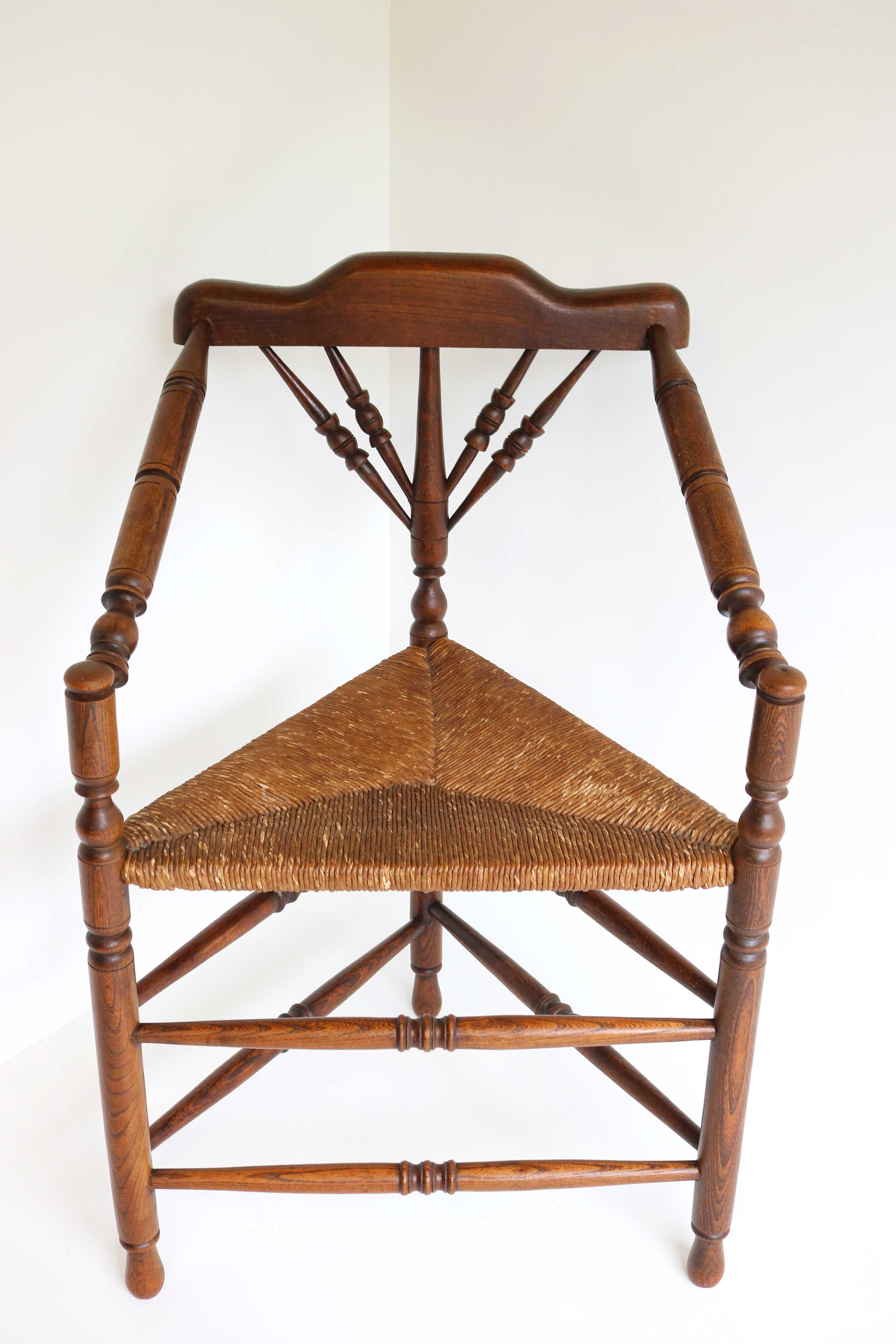 Late 19th century Edwardian style wooden armchair with rush seat, ca 1900
Manufactured in U.K.
Beautiful English antique knitting chair with three legs.
This old sturdy chair with turned legs is called a knitting chair.
Because of the slanted