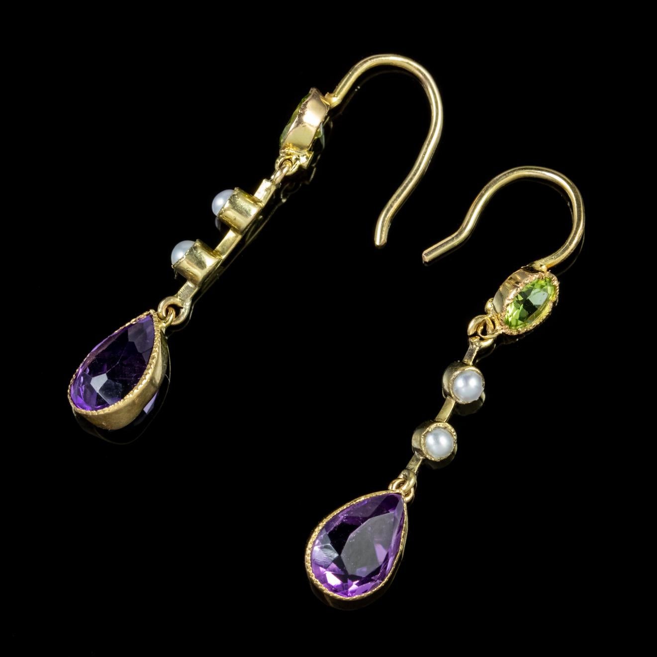 A fabulous pair of Suffragette drop earrings from the Edwardian era decorated with Peridots, Pearls and dangling teardrop Amethysts. 

Suffragette jewellery was worn to show one’s allegiance to the women’s Suffragette movement in the early 20th