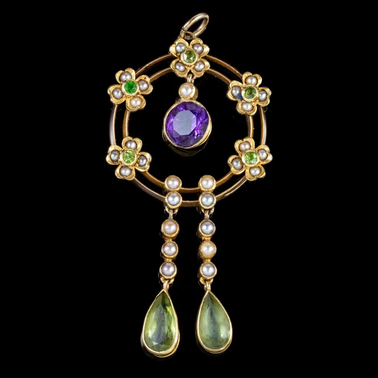 A colourful Antique Edwardian Suffragette pendant featuring two swinging droppers decorated with Pearls and two lovely approx. 0.60ct Peridots with a fabulous swinging Amethyst dropper in the centre which is approx. 0.75ct. 

Suffragette jewellery