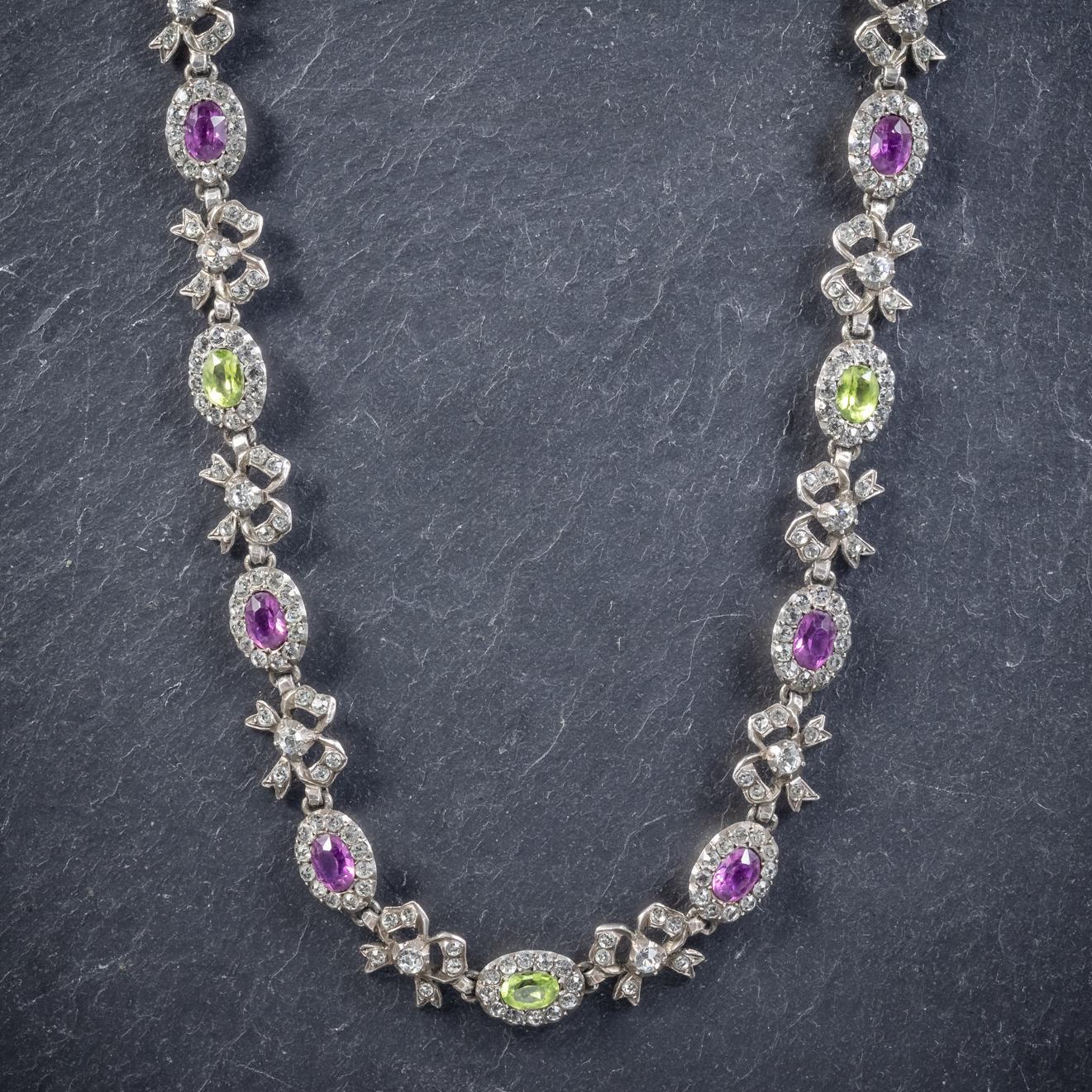 This vibrant antique Silver Suffragette riviere necklace is Victorian, Circa 1910. 

Adorned with lovely violet Amethyst’s, olive green Peridots and sparkling white Paste Stones that make up the Suffragette colours. 

The stones are set in round