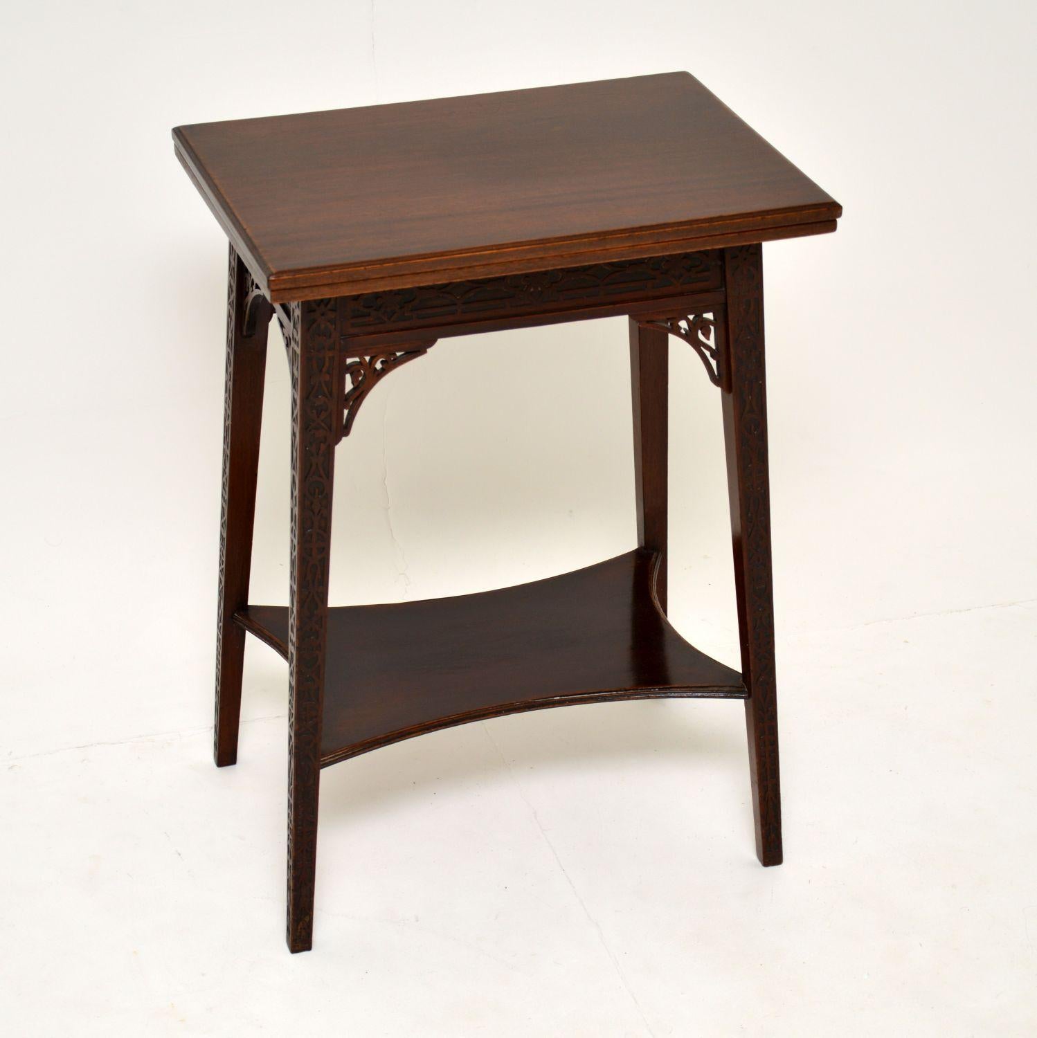 This stunning and unusual antique Edwardian side table, has a flap over top which doubles the top surface and turns it into a tea table or card table. This is beautifully made of wood, it dates from the 1890-1900 period.

There is fine carving all