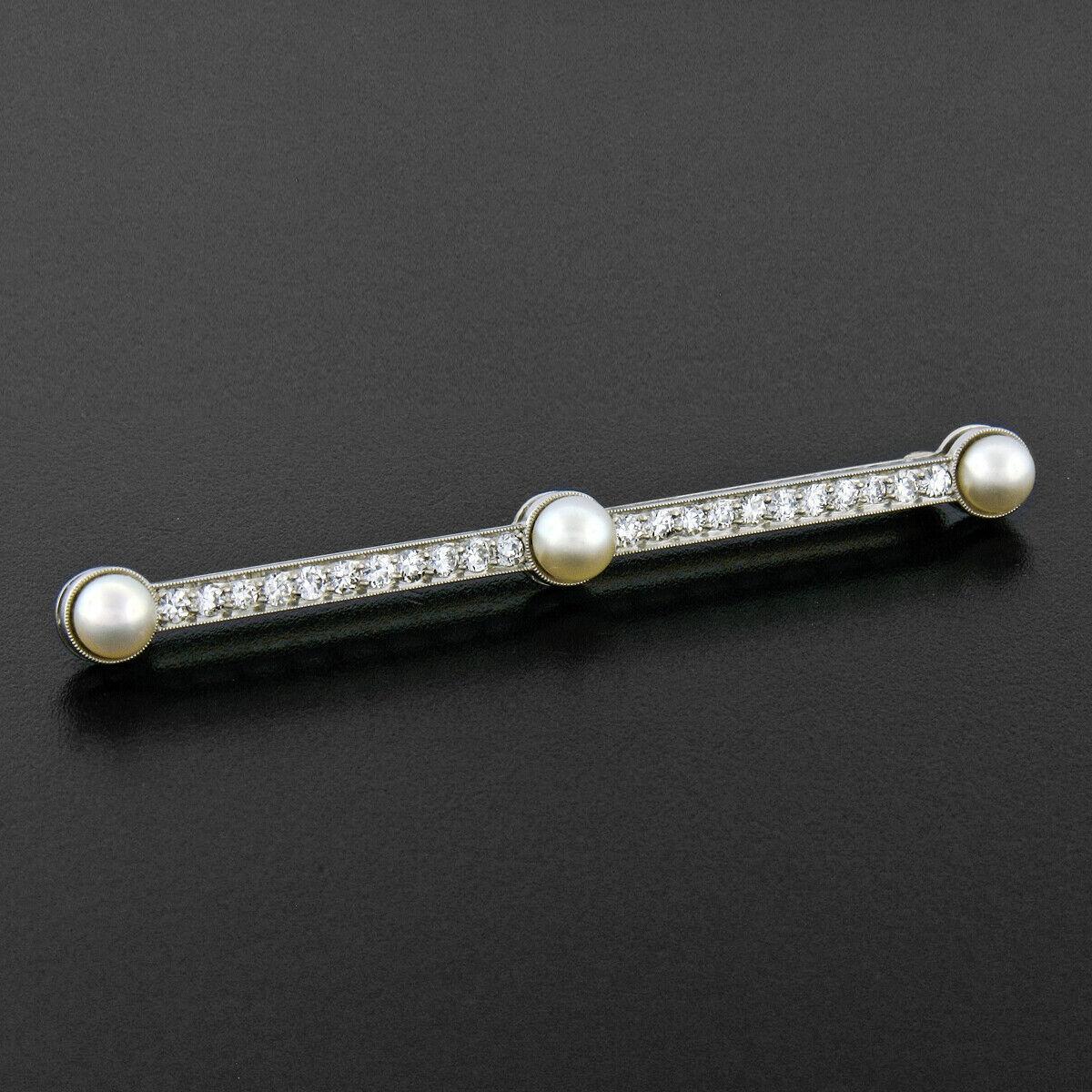 This magnificent, antique, Tiffany & Co. bar pin was crafted from solid .900 platinum and 14k yellow gold during the Edwardian era. The pin features 3 natural round pearls set into the center and at the ends. The remainder of the pin is pavé set