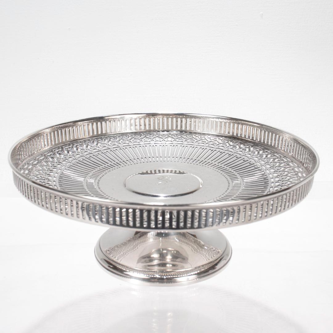 A fine reticulated silver cake stand or tazza. 

By Tiffany & Co.

In sterling silver.

With an ornately pierced side wall and bowl supported on a trumpet form base. Monogrammed to the interior with an 'S' monogrammed and fully hallmarked to the