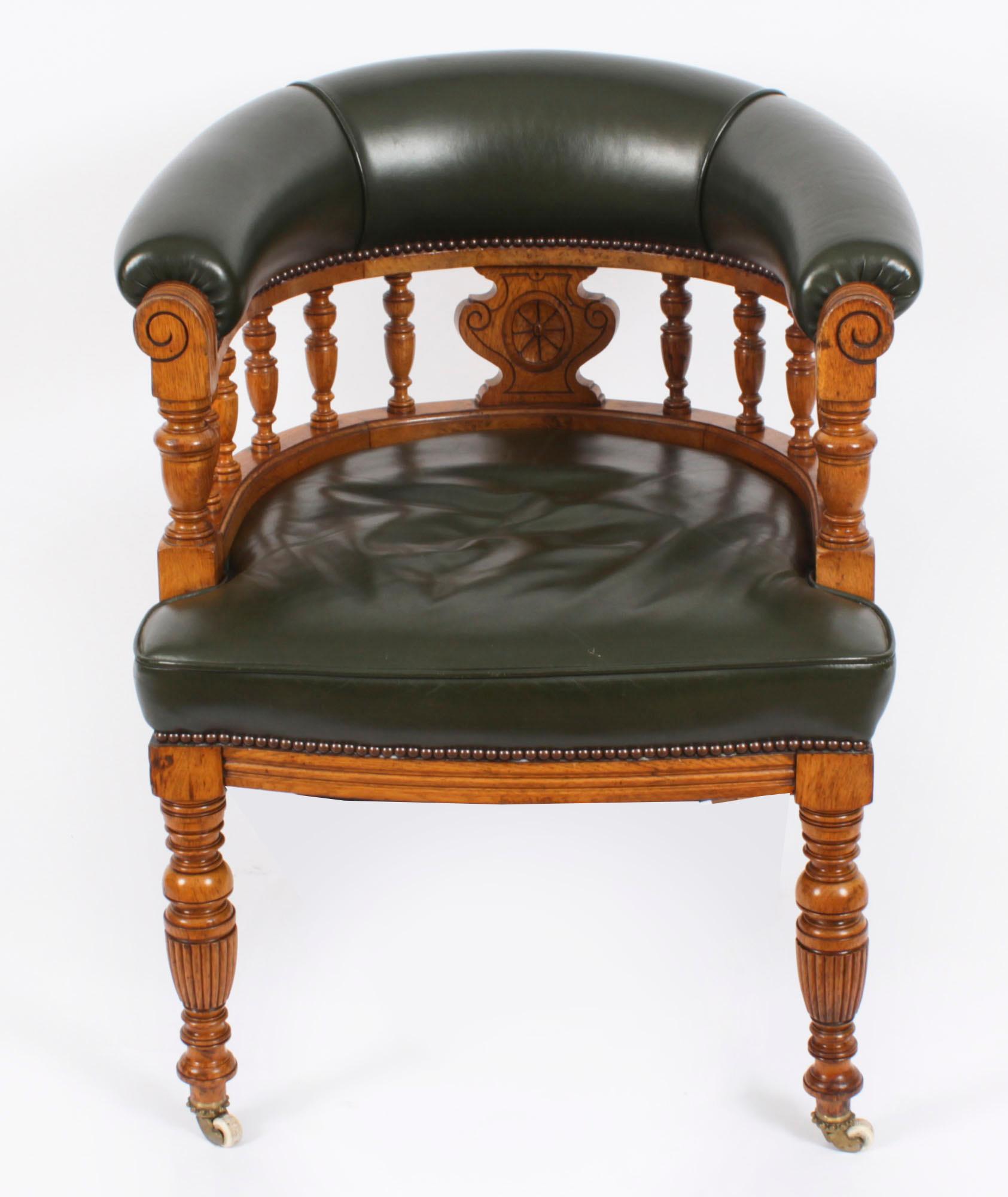 This is a very elegant antique Victorian tub desk walnut armchair, circa 1880 in date.

An Edwardian honey oak and green leather upholstery desk chair, circa 1910 in date.

The chair features a curved back with turned balustrade spindles and padded