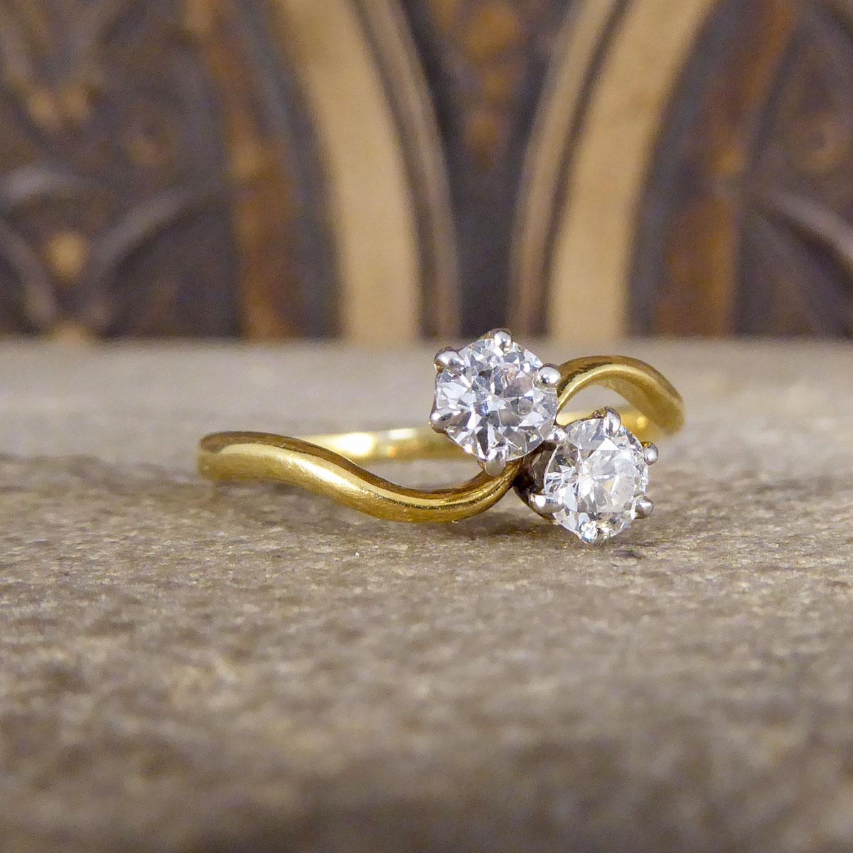 A very elegant two stone diamond twist ring that is set with two sparkling diamonds weighing a total of 0.40ct. The stones are set in 18ct White Gold claw setting on the top leading down to an fine 18ct Yellow Gold band. Such a beautiful antique