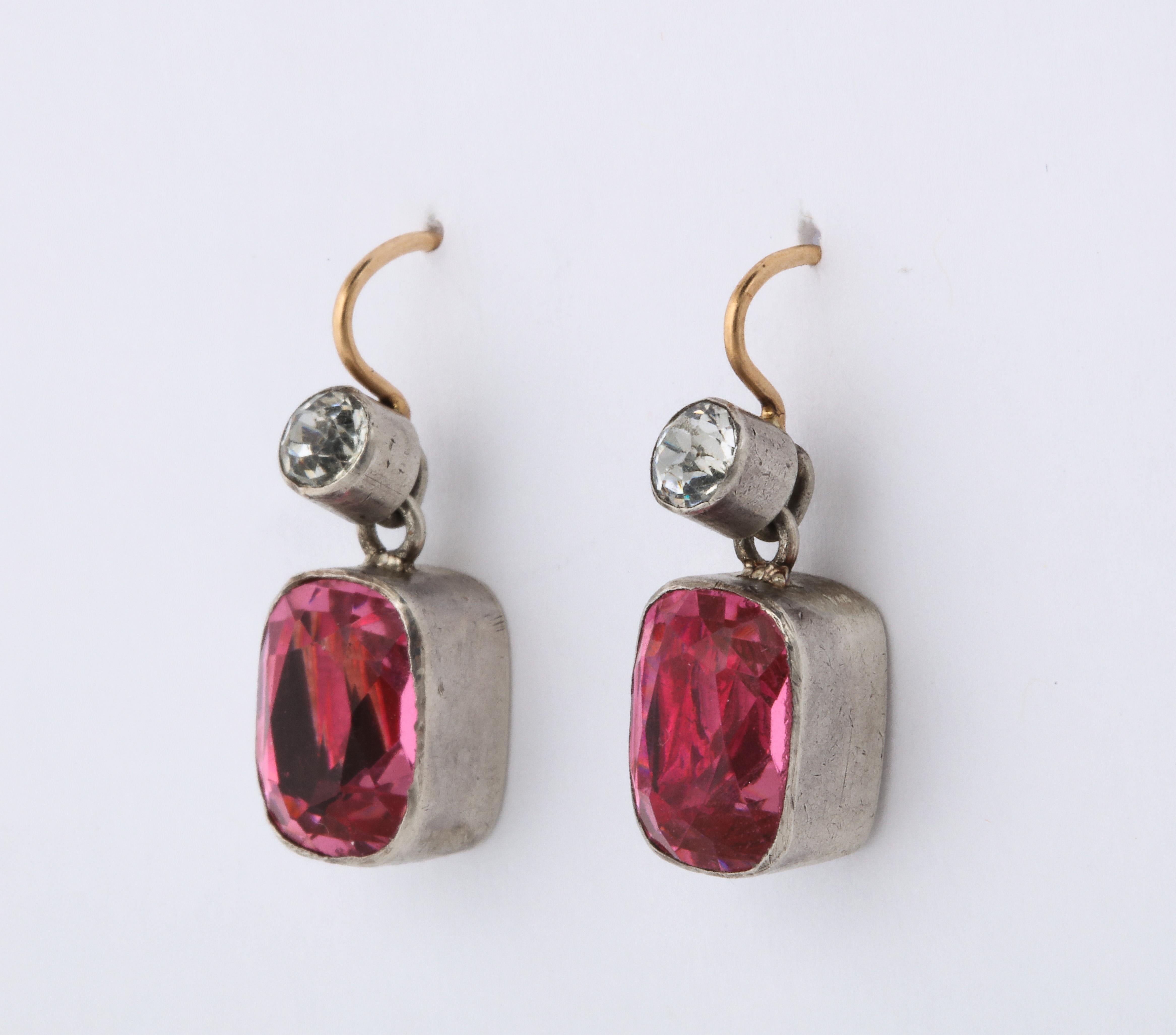  These vivid pink paste Edwardian dangle earrings will compliment every skin tone. The deep silver collet is closed backed and foiled to enrich the pink and white round stones. They were originally from an Edwardian necklace to which we have added