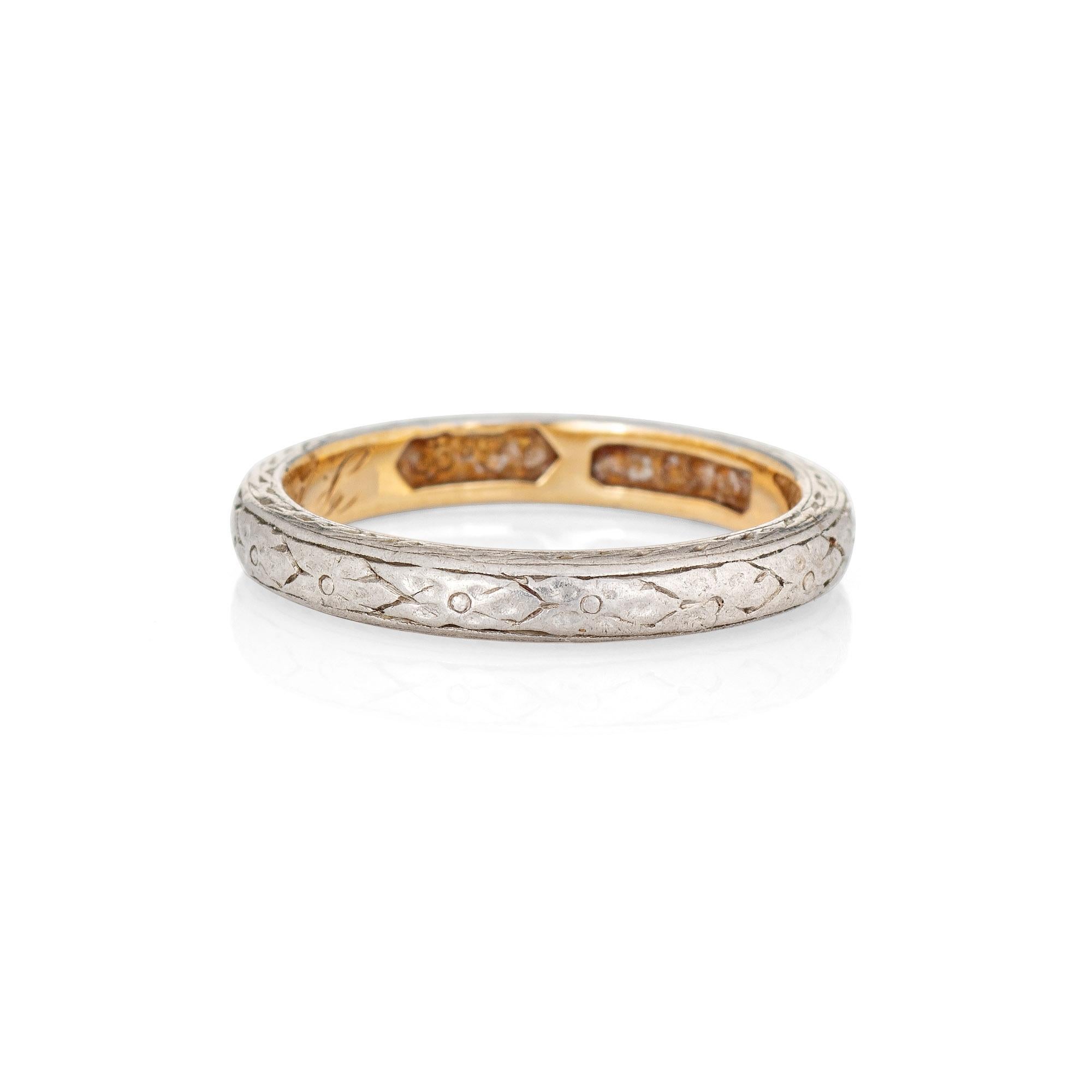 Finely detailed vintage Art Deco wedding band (circa 1908) crafted in 18k yellow gold and 900 platinum. 

The stylish Edwardian era ring features an embossed floral pattern rendered in platinum to the exterior of the band, with the inner band