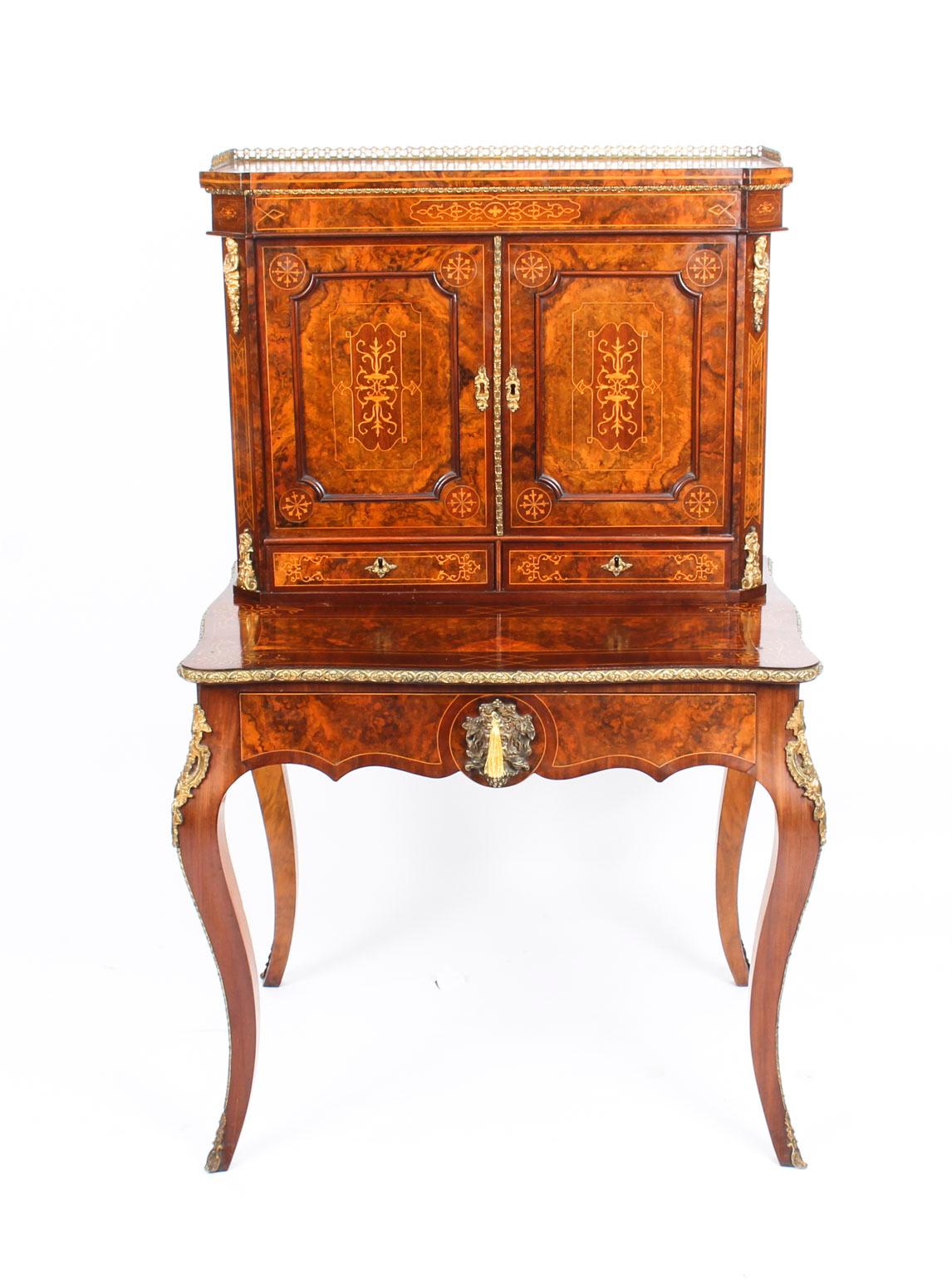 This is a gorgeous antique burr walnut, marquetry inlaid and ormolu-mounted Bonheur Du Jour or ladies writing desk, circa 1870 in date and bearing the maker stamp of the renowned London cabinet maker and retailer Edwards & Roberts.

This splendid