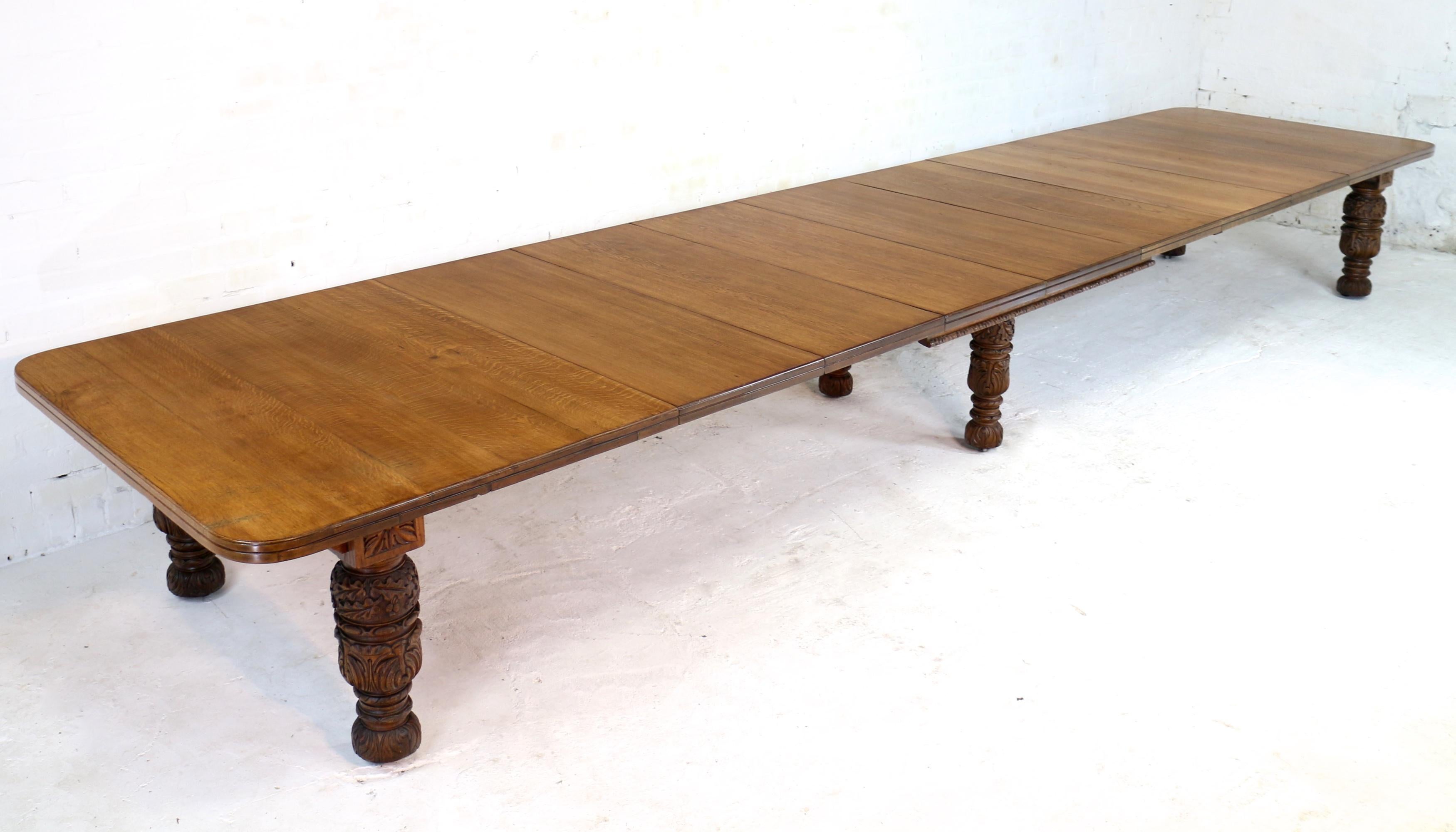 Magnificent Edward & Roberts Victorian wind-out extending dining table in golden quarter-sawn oak and with seven leaves. In the Jacobean Revival style this large 54in wide table smoothly extends from 7ft 4.5in to 20ft using a double Joseph Fitter