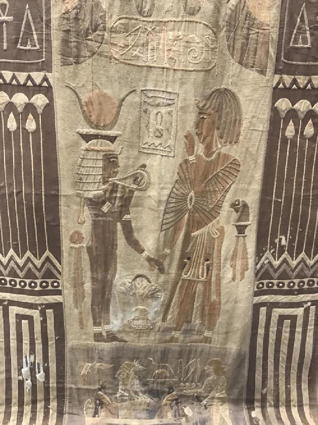 Antique Egyptian design French patchwork textile Tapestry in brown and beige toned fabric depicting Egyptian Figurals in center panels and hieroglyphics flanking each side, some damage and discoloration to areas of piece. Egyptian Themed Wall