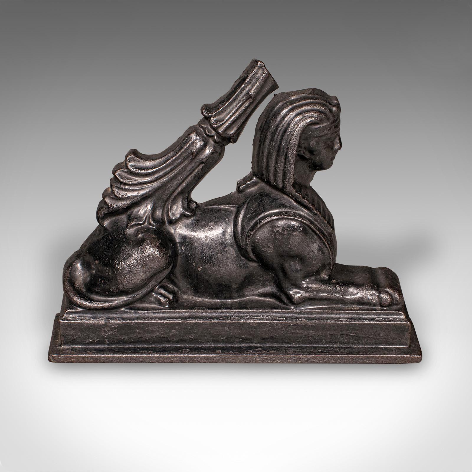 This is an antique Egyptian revival doorstop. An English, cast iron door keeper in Sphinx form, dating to the late Regency period, circa 1830. A wonderfully evocative piece of early 19th century interior decor, celebrating Britain’s fascination with