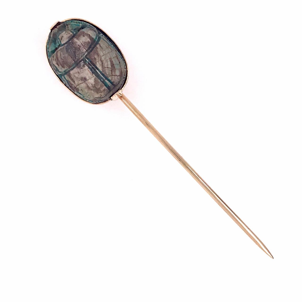 A fine Egyptian Revival stick pin.

In 14k yellow gold.

Set with a possibly ancient Egyptian faience scarab.

Simply a wonderful stick pin!

Date:
Late 19th or Early 20th Century

Overall Condition:
It is in overall good, as-pictured, used estate