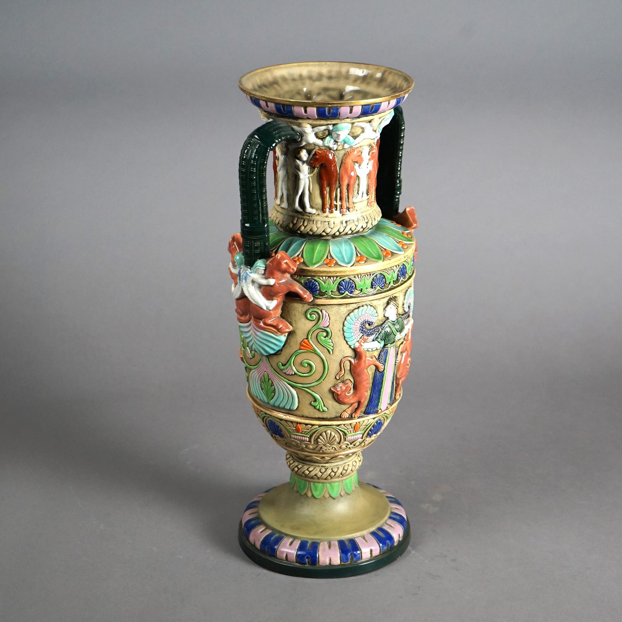 An antique Egyptian Revival vase offers Majolica Amphora Teplitz  pottery construction with enameled decoration, horses and figures, signed on base as photographed, c1910
Vase C1910

Measures- 18''H x 8.5''W x 8.5''D