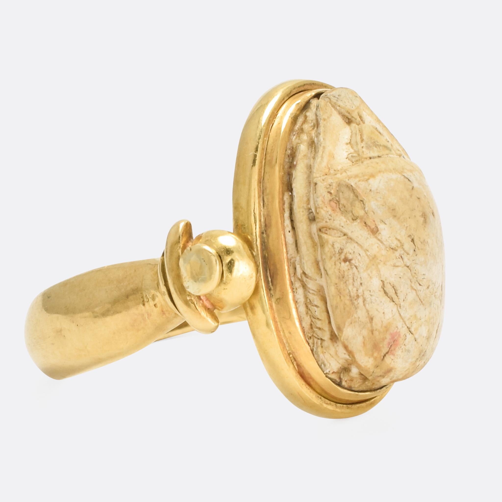 A very cool Egyptian Revival Scarab Spinner ring dating from the late Victorian period, circa 1900. Modelled in 18k gold throughout, the faience scarab can flip round to display the Cartouche carved onto the back.

STONES 
Faience Scarab

RING