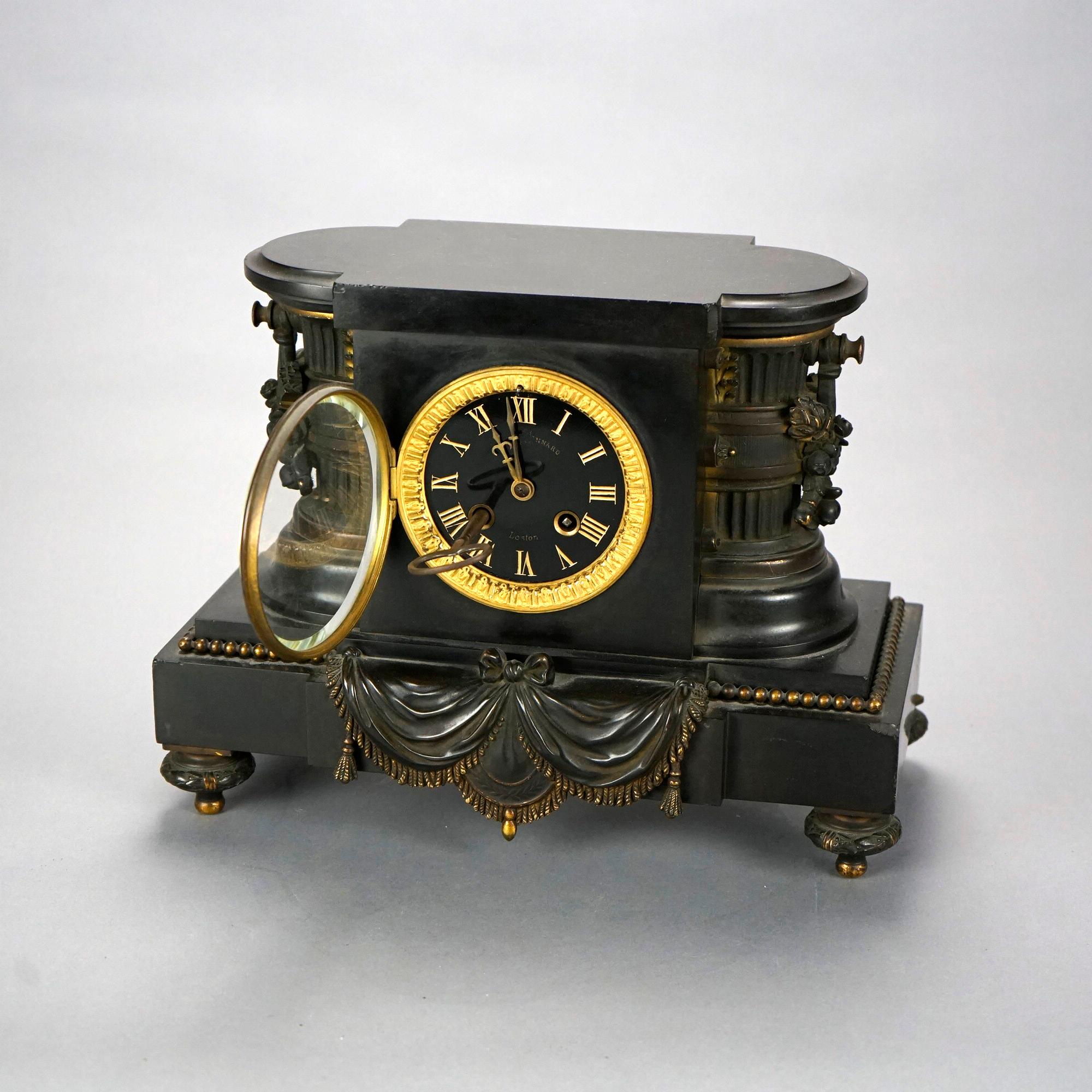 An antique French Egyptian Revival mantel clock retailed by Bigelow, Kennard & Co., Boston offers slate case with flanking columns, gilt decorated base and raised on Marseilles feet, 19th century

Measures- 10''H x 13.25''W x 6.75''D