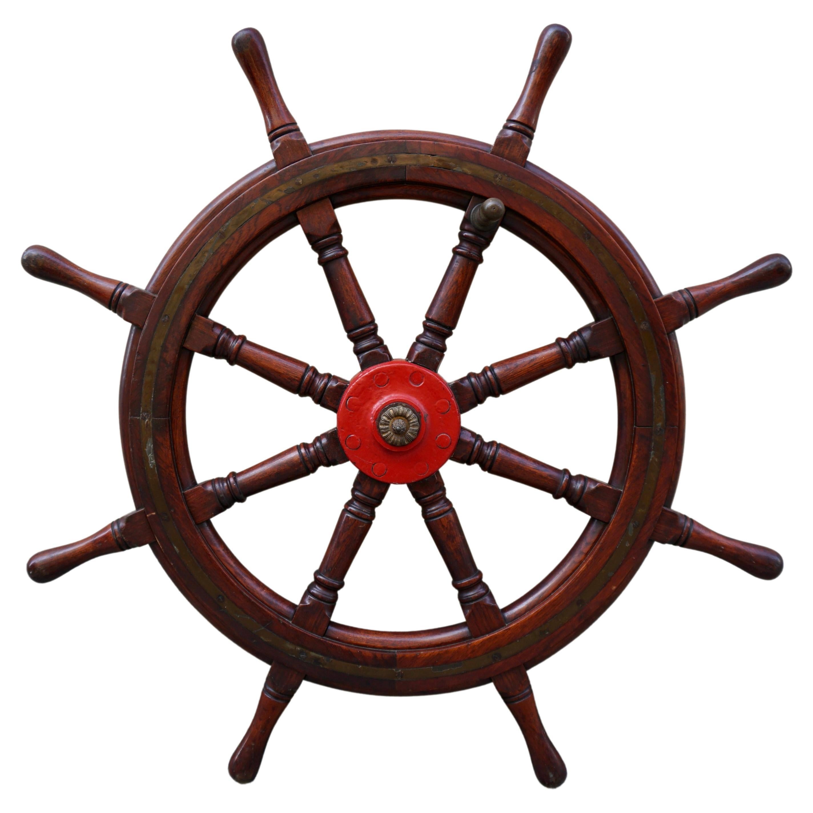 This is a superb and very large antique Victorian mahogany and brass set ships wheel, circa 1880-1900 in date. This exceptional nautical collectable features eight elegant trunking cylindrical spokes ending in handles, and made from beautiful