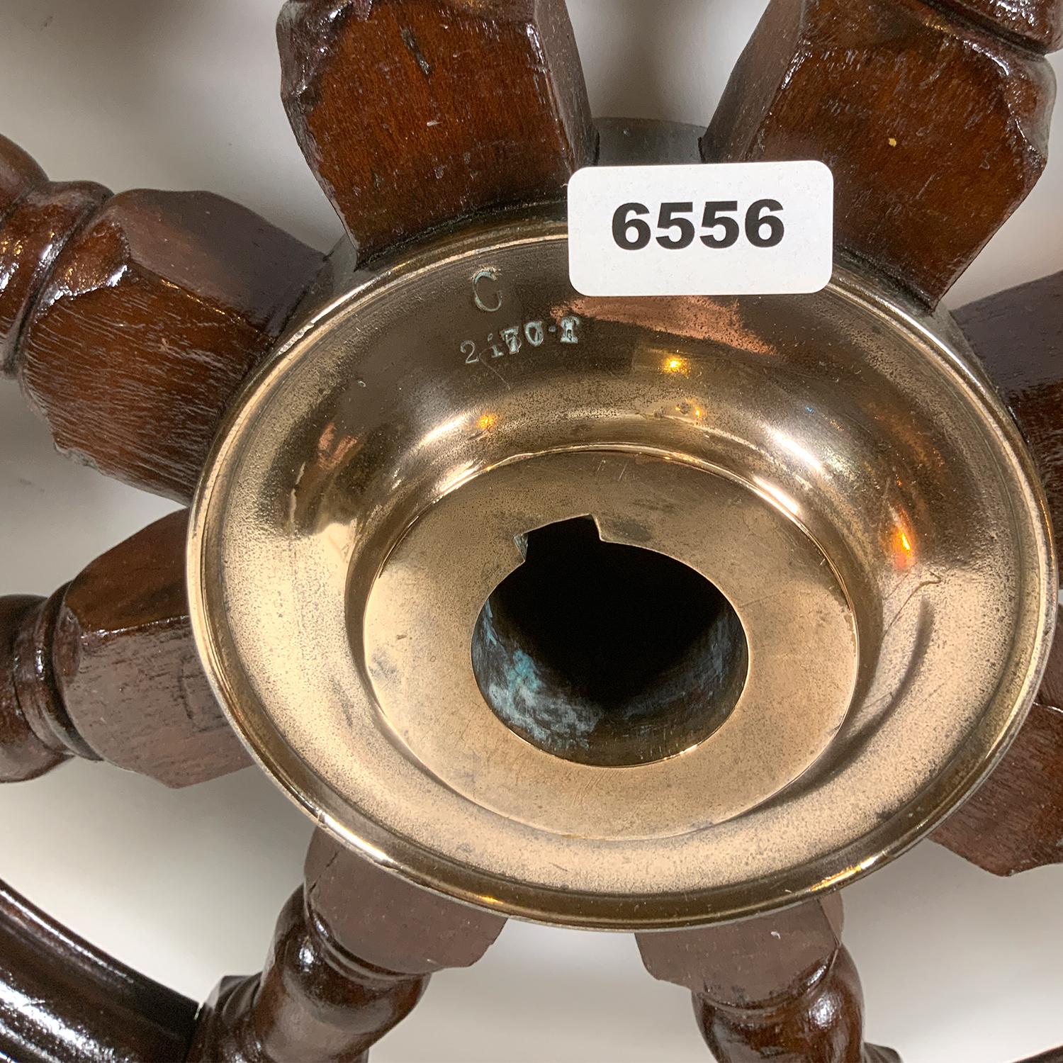 Fine late nineteenth century ships or yacht wheel. Very fine varnish finish. The brass trim ring and center hub have been meticulously polished. Brass acorn cap on one of the eight turned spindles.