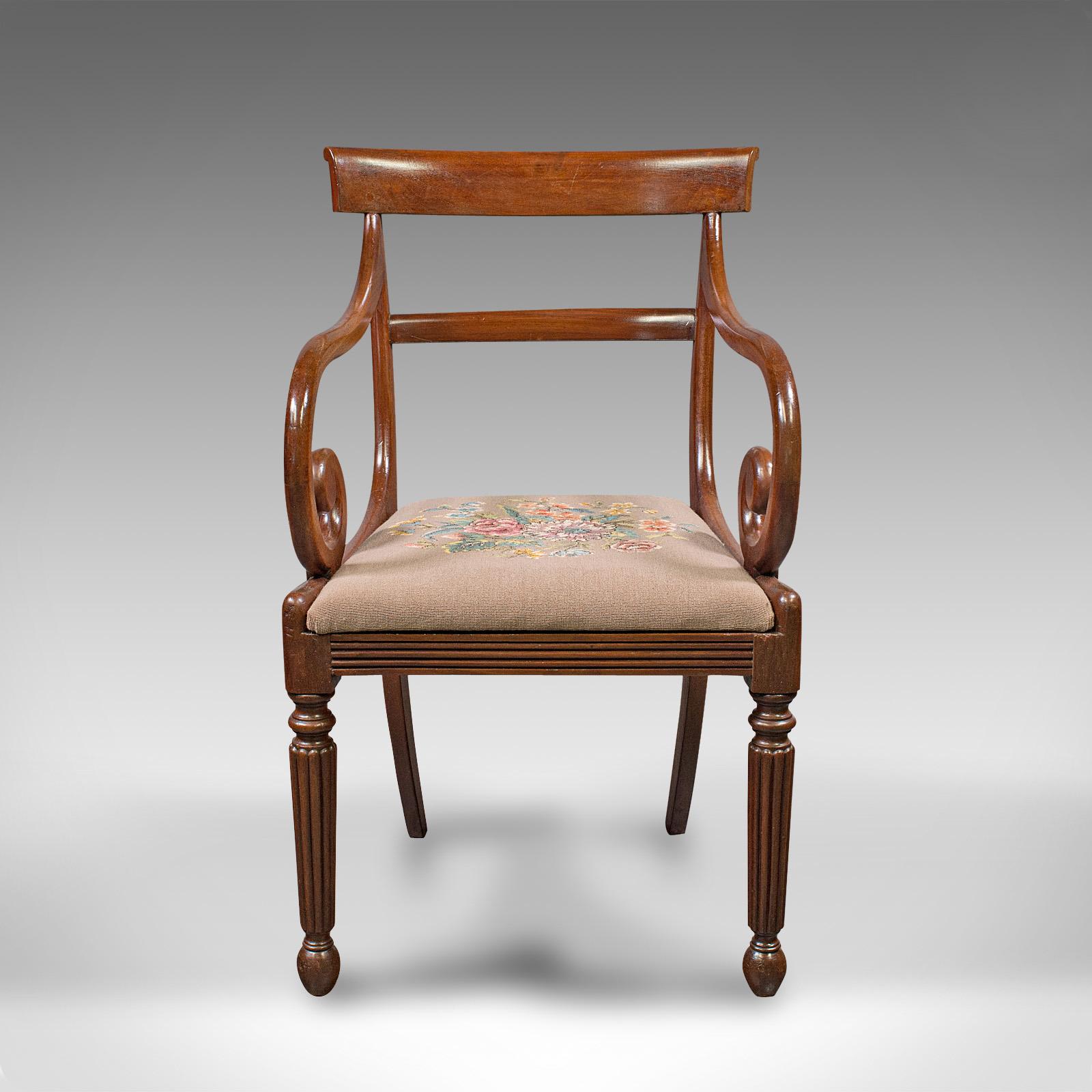 This is an antique elbow chair. An English, mahogany armchair with needlepoint upholstery, dating to the Georgian period, circa 1800.

Serpentine forms with fine colour and finish
Displays a desirable aged patina and in good order
Select stocks
