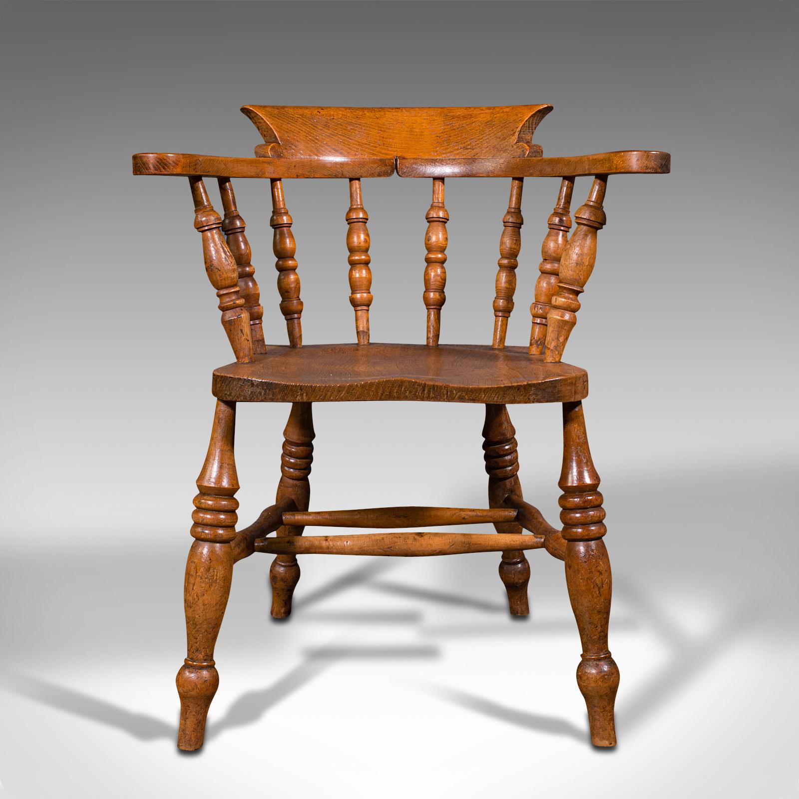 This is an antique elbow chair. An English, beech and elm smoker's bow or captain's chair, dating to the Victorian period, circa 1900.

Country house appeal with classic bow form
Displays a desirable aged patina and in good order
Select elm and