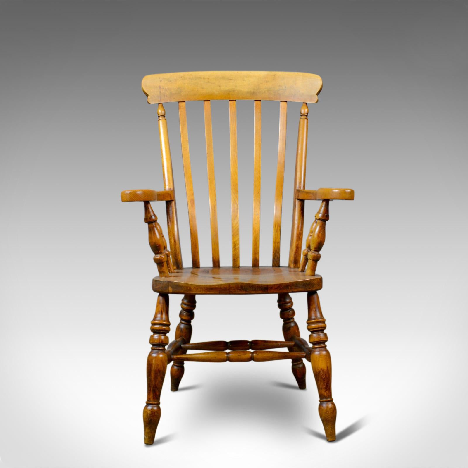 This is an antique elbow chair. An English, country kitchen, Windsor, lath back, armchair in beech, dating to the early 20th century.

Super chair in fine order throughout
Classic, lath back design offering a comfortable seat
Good color and a