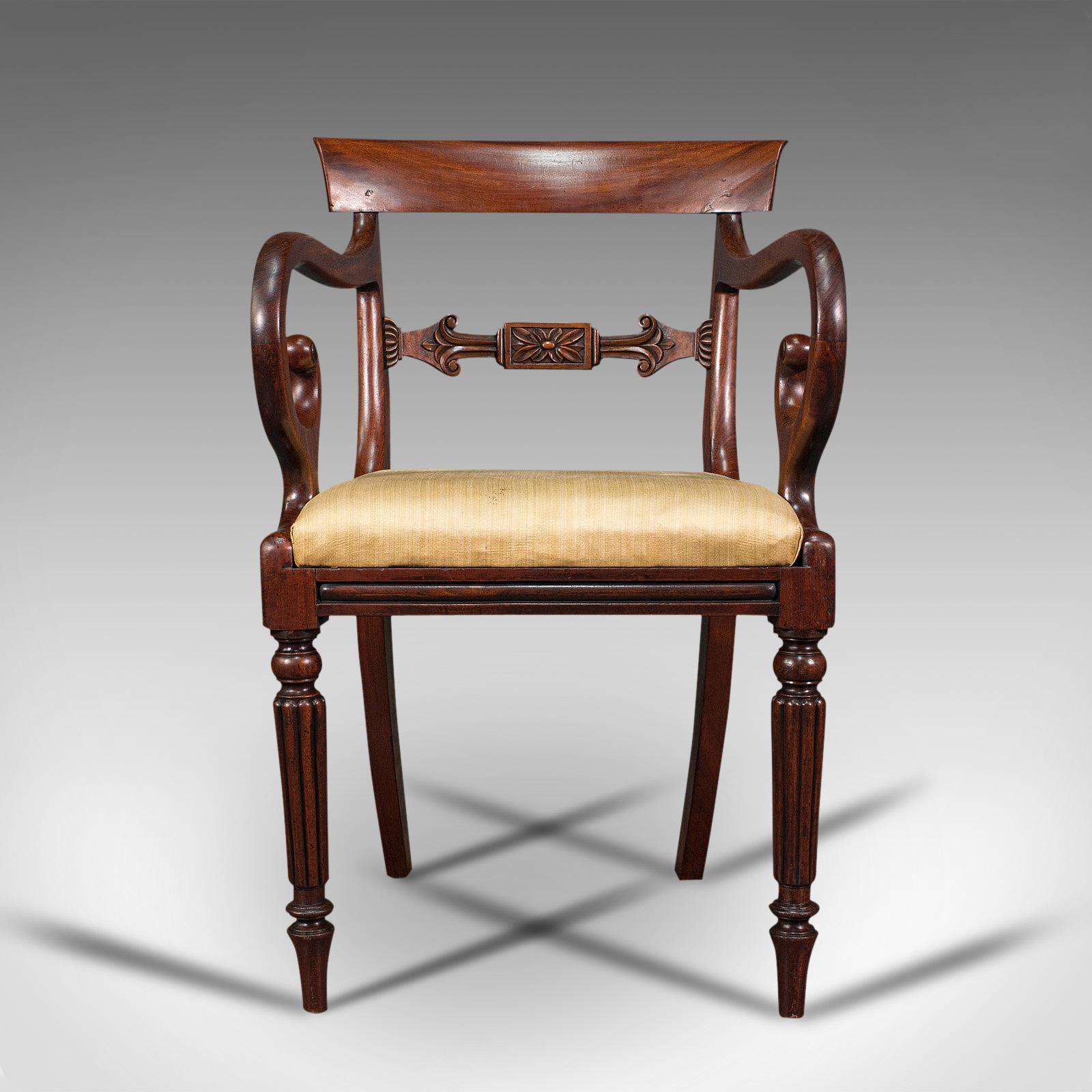 This is an antique elbow chair. An English, mahogany carver with drop-in seat, dating to the Regency period, circa 1820.

Serpentine elegance as to be expected from the Regency period
Displays a desirable aged patina and in good order
Delightful