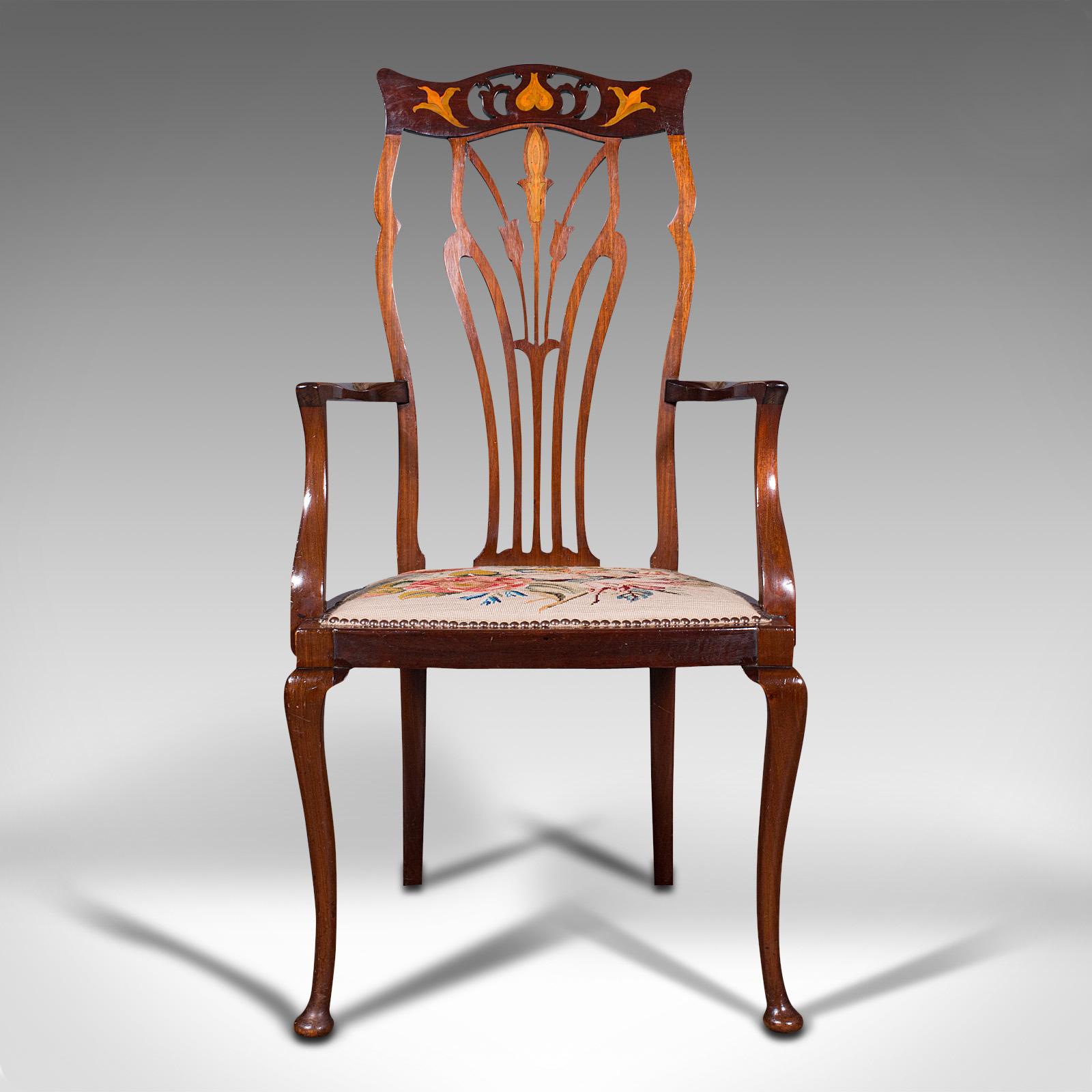 This is an antique elbow chair. An English, mahogany inlaid occasional seat in Art Nouveau taste, dating to the late Victorian period, circa 1900.

Distinguished with elegance and Art Nouveau decoration
Displays a desirable aged patina and in