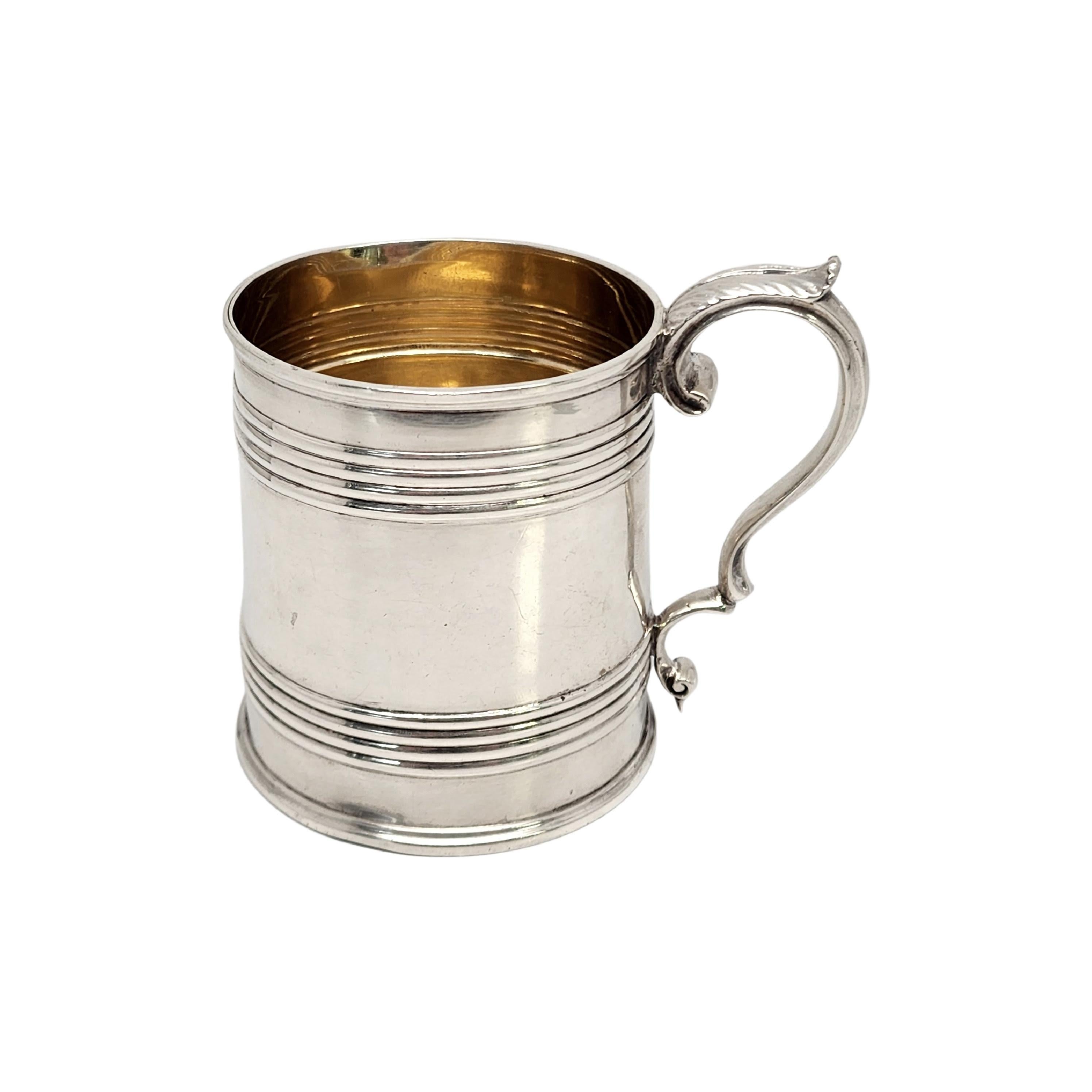 Antique sterling silver with gold wash interior cup by Elder & Co of Edinburgh, Scotland, circa 1832.

Barrel like design cup/mug featuring a delicately curved handle with leaf design at top. Gold washed interior. Etched detail of a hand holding a