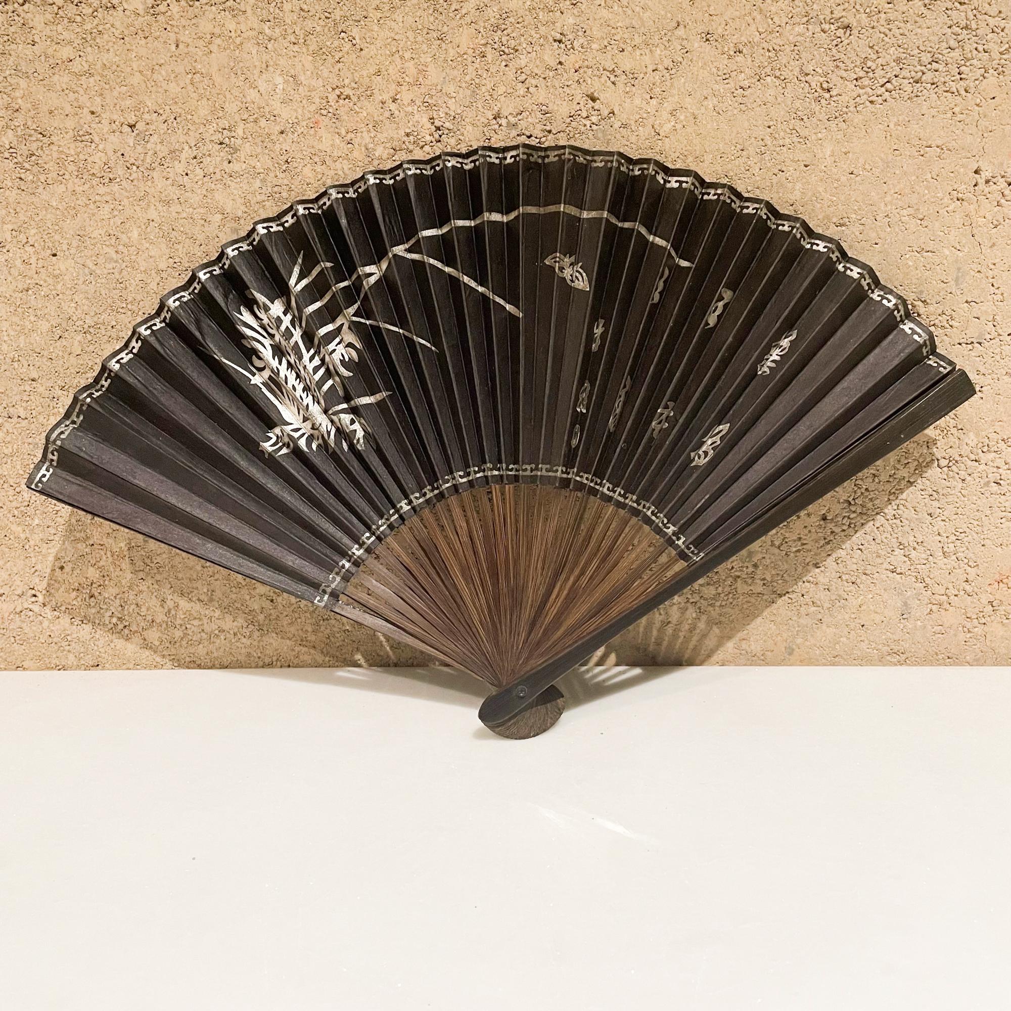 Folding fan
Antique Elegance Japanese black compact folding fan in exotic rosewood 
Lovely decorative art in Asian detail.
Measures: 7.88L x .88 W x .38 thick, closed 13 W open inches
Preowned unrestored vintage condition.
Refer to