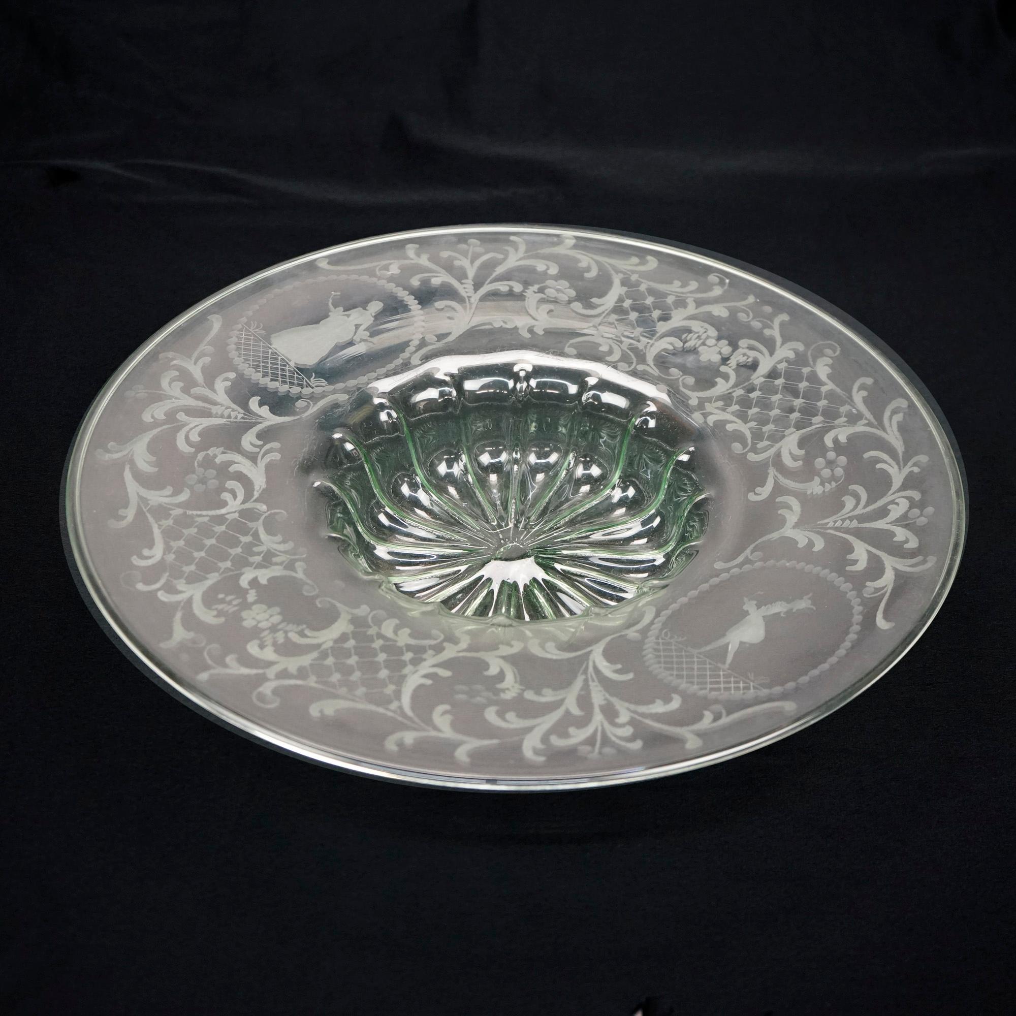 An antique Elegant Glass center bowl offer wide rim with flanking etched female cameos with foliate and scroll decoration throughout, glass with slight green tint, c1920

Measures- 3''H x 17.5''W x 17.5''D

Catalogue Note: Ask about DISCOUNTED