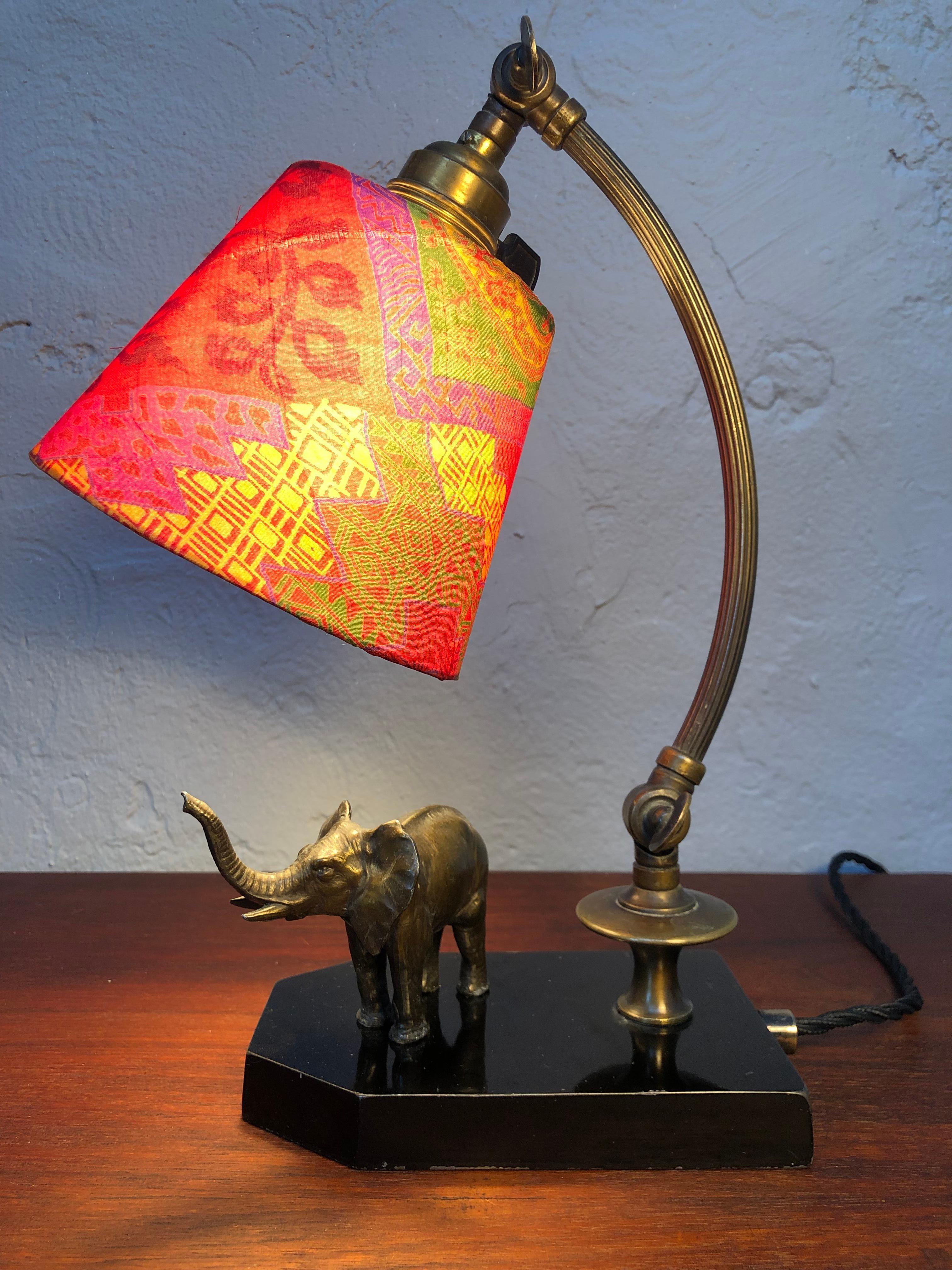 A lovely antique elephant table piano lamp in brass.
Original shade refurbished with silk from an antique kimono.
Original brass and ceramic bulb holder with an on/off switch.
Painted metal base that has age related patina in the form of chips