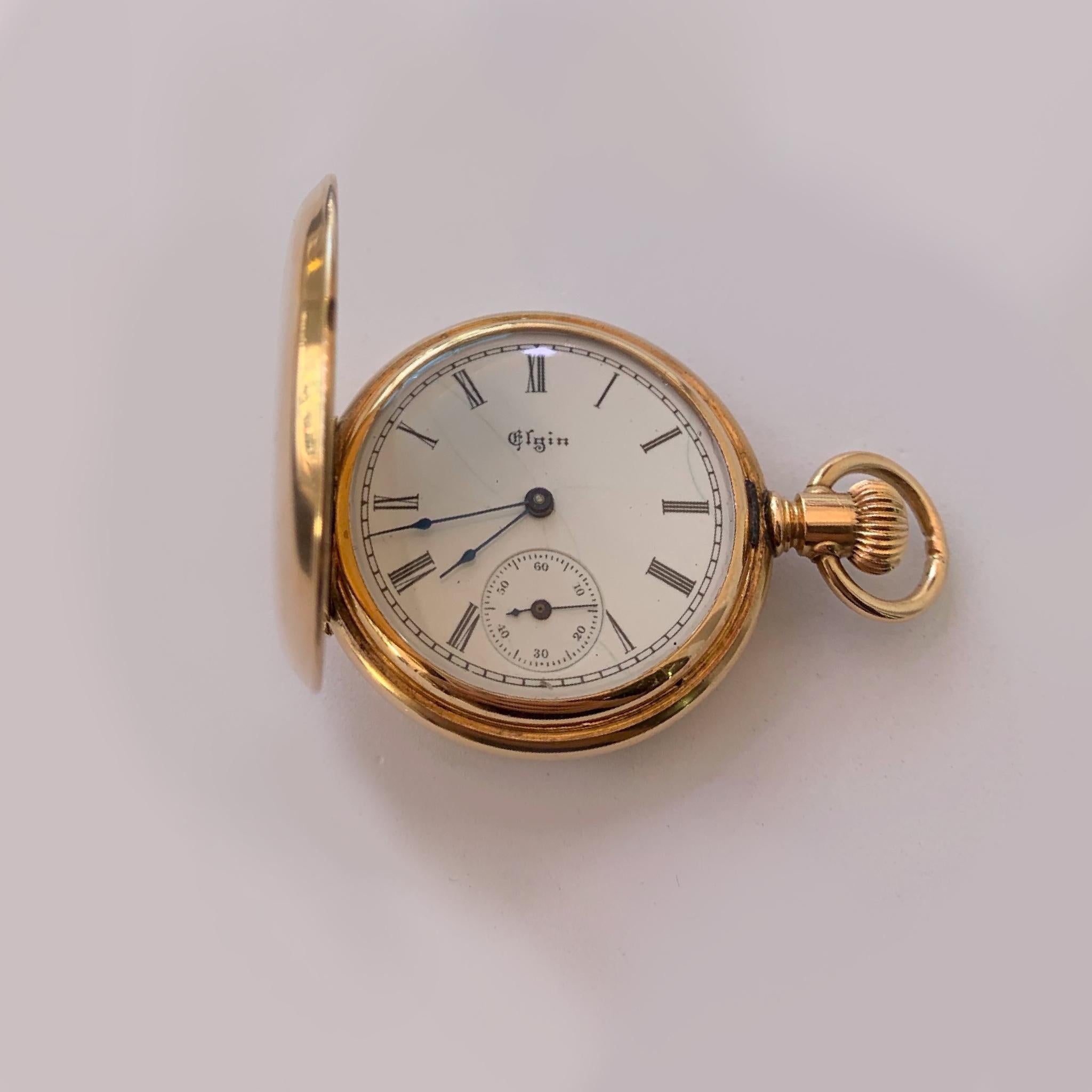 This beautiful antique Elgin pocket watch circa 1895 is a true collectible. The hunting case has an inner dust cover and is set with a beautiful rose and old mine cute diamonds with a total weight of approximately .23 carats. It is 34 inches