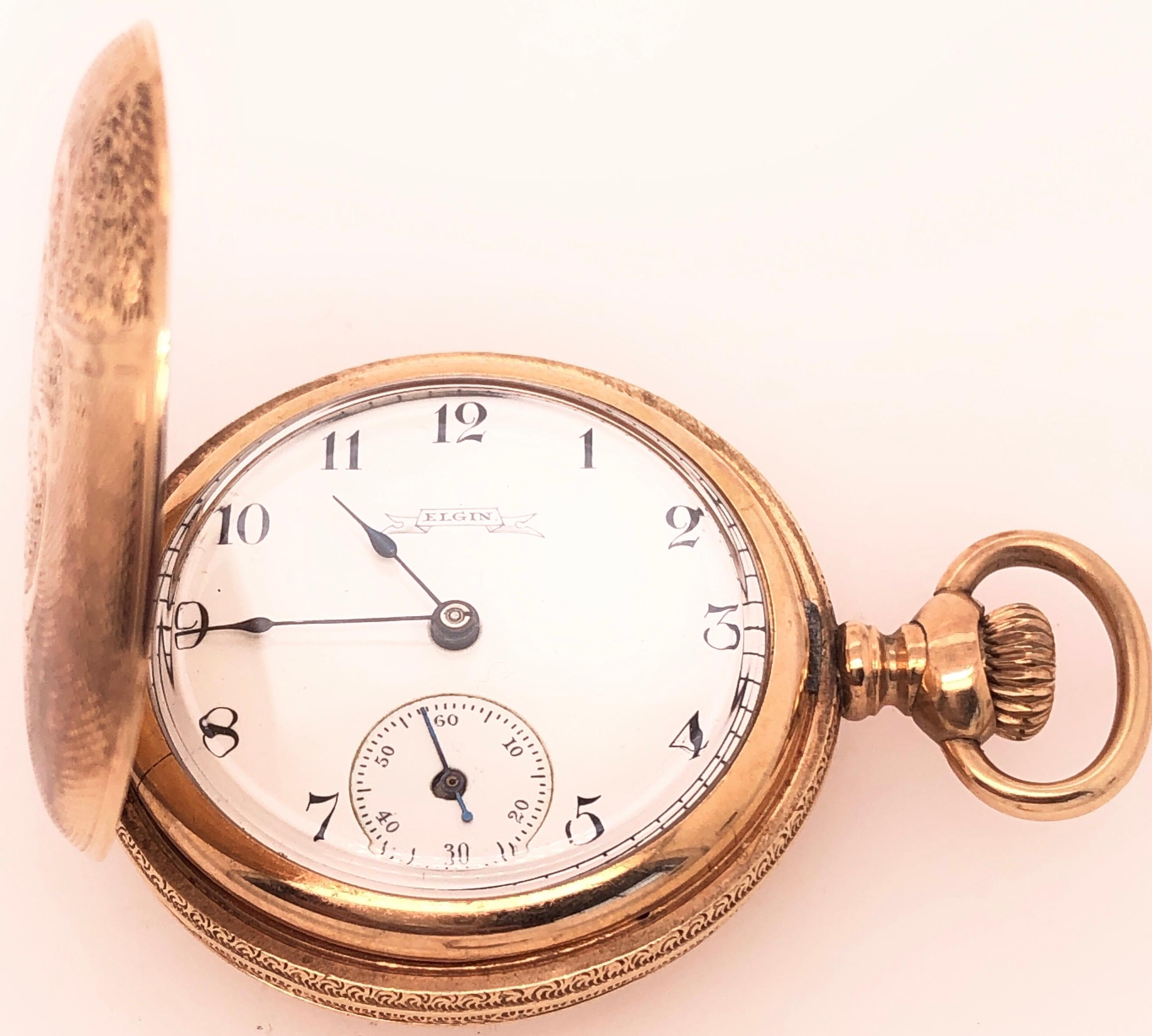 Antique Elgin 14 Karat  Yellow Gold Pocket Watch.
This beautiful antique Elgin pocket watch circa 1895 is a true collectible. The hunting case has an inner dust cover and is set with a beautiful engraved. It is 32 mm diameter, movement no. 14975105.