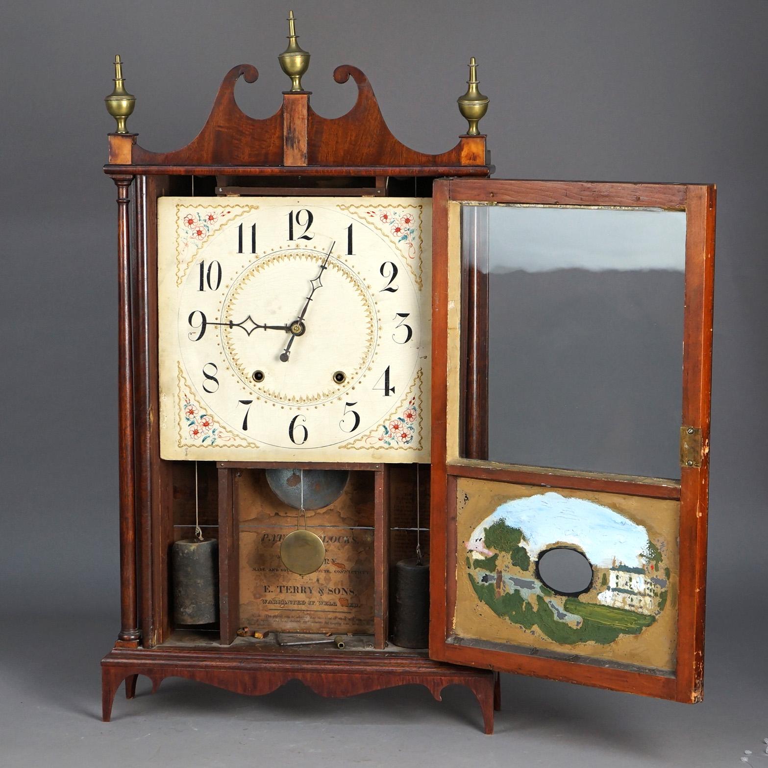 Antique Eli Terry Pillar & Scroll Mantle Clock with Mahogany Case, Eglomise Panel & Brass Finials C1830

Measures- 31''H x 17.5''W x 4.5''D