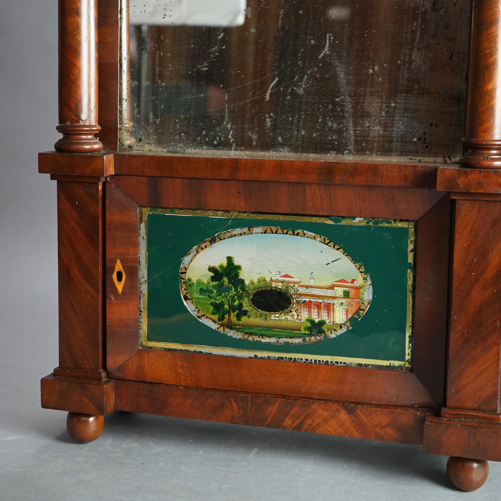 ***Ask About Reduced In-House Delivery Rates - Reliable Professional Service & Fully Insured***
Antique Eli Terry School American Empire Flame Mahogany Open Escapement Mantle Clock with Foliate Carved Crest, Flanking Columns and Eglomise Glass Panel