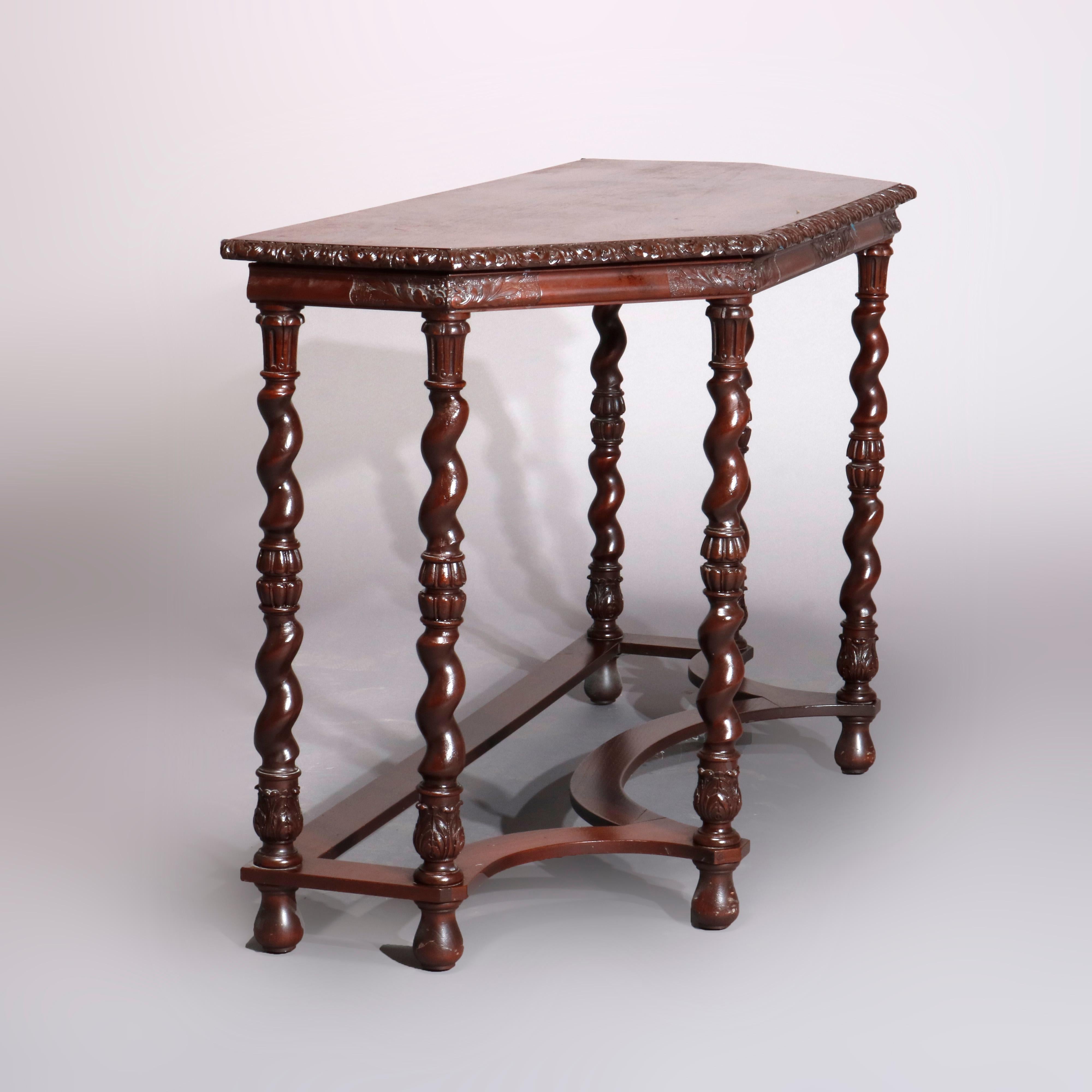 An antique English Elizabethan console table offers clipped corner top with carved foliate bordering raised on barley twist legs having acanthus bases and shaped stretcher base, circa 1930

Measures: 29.5