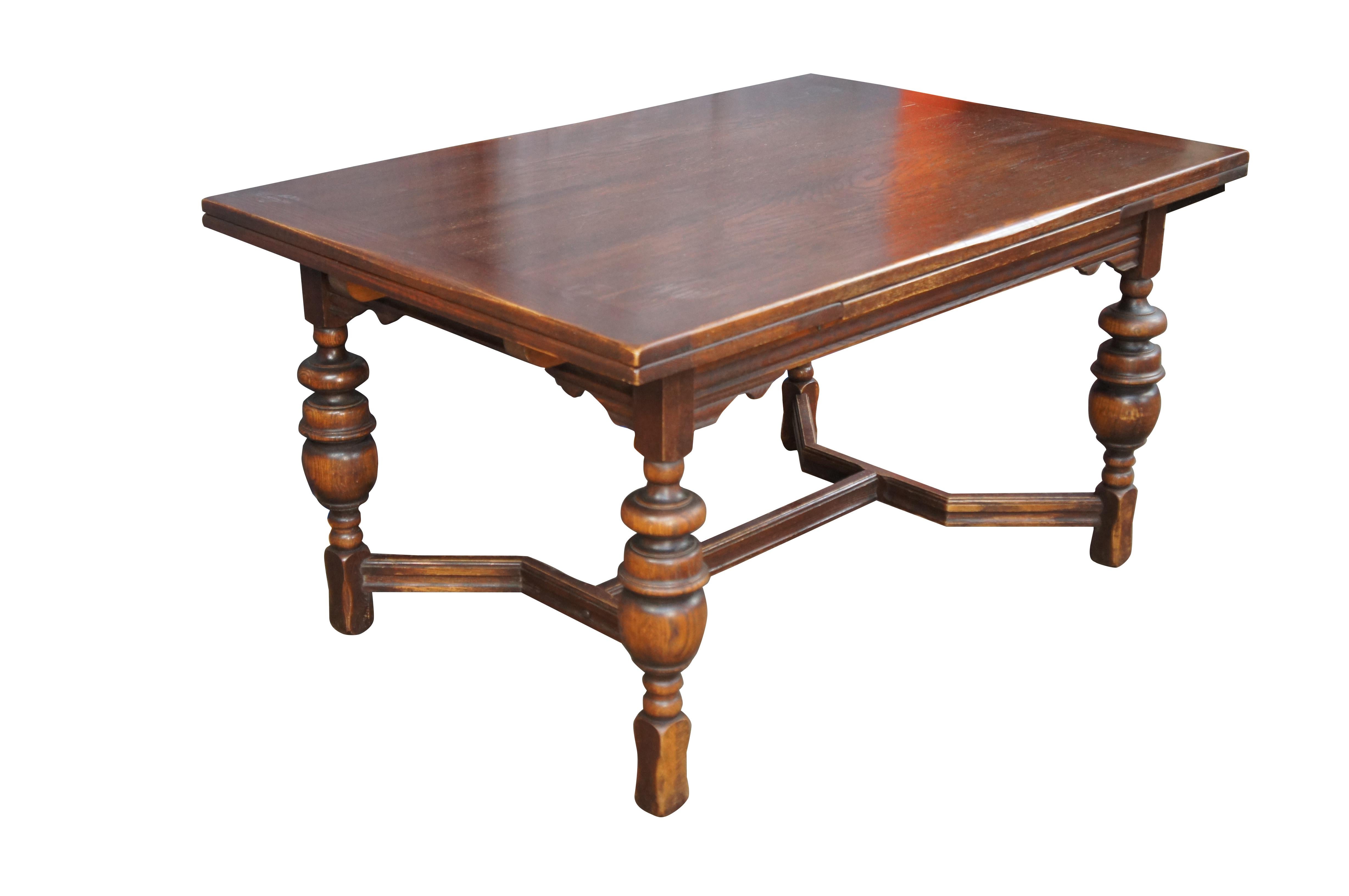 Early 20th Century Jacobean style draw leaf dining table.  Features a rectangular form with two 15