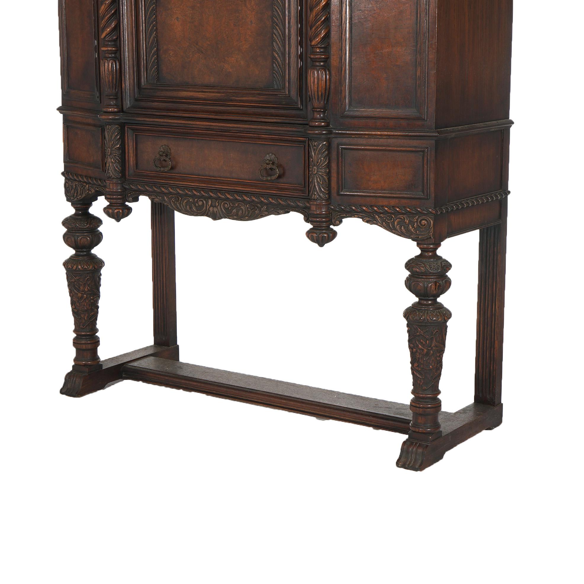 ***Ask About Reduced In-House Delivery Rates - Reliable Professional Service & Fully Insured***
An antique Elizabethan Jacobean style blind door credenza offers oak construction with broken arch crest over single door cabinet having rope twist